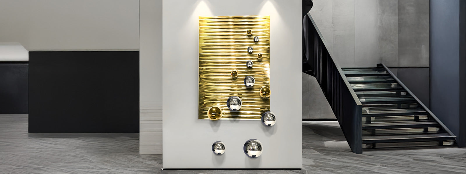 A modern art installation featuring a gold, wavy panel with circular metallic accents of varying sizes on a white wall. The setting is a minimalist interior with a ramp and sleek gray floor.