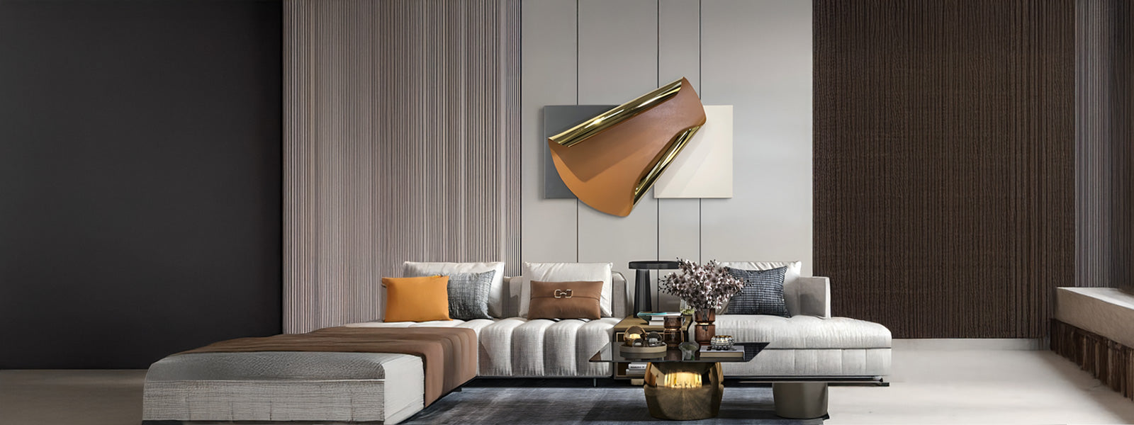 Modern living room with a beige sectional sofa accented with orange and brown cushions. A geometric wall art piece hangs above, and a sleek coffee table holds decorative items. The room is softly lit and elegant.