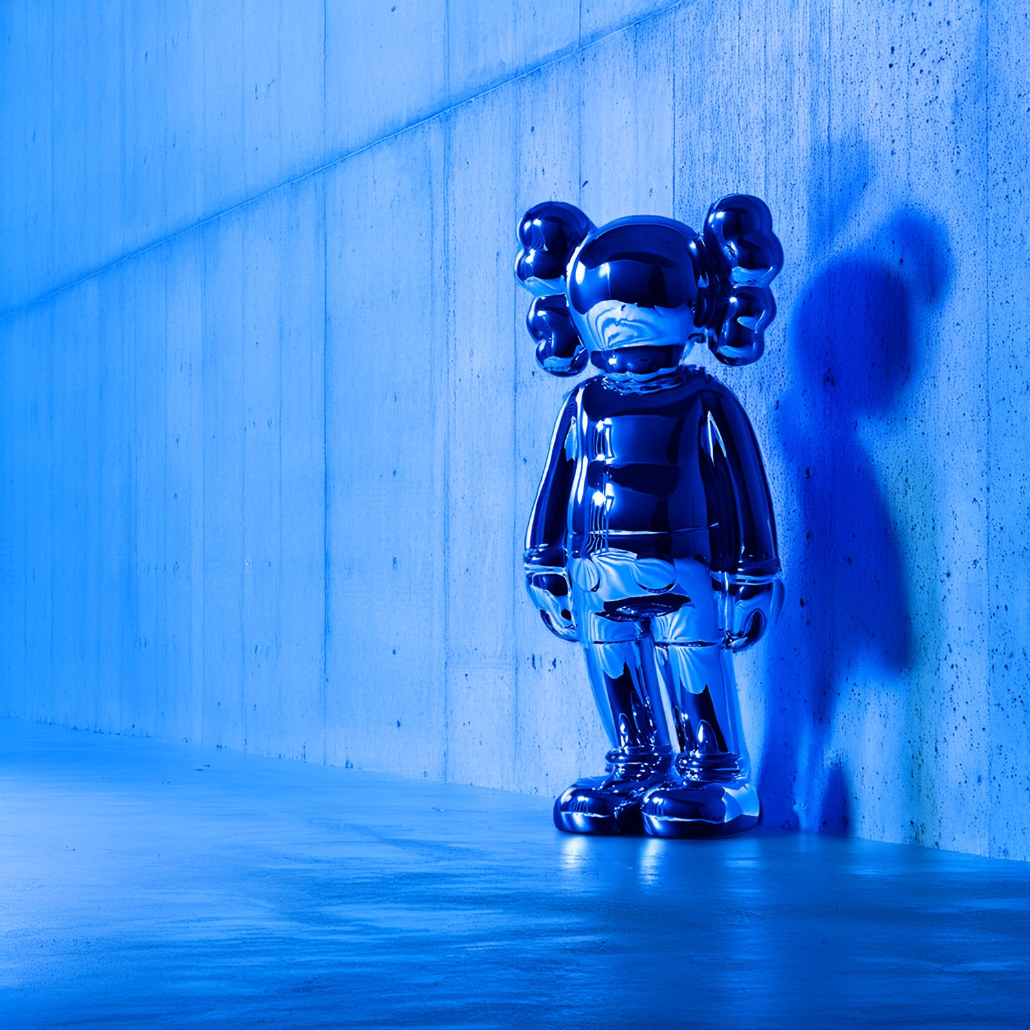 Iconify blue chrome sculpture standing against concrete walls, a luxury contemporary art piece.