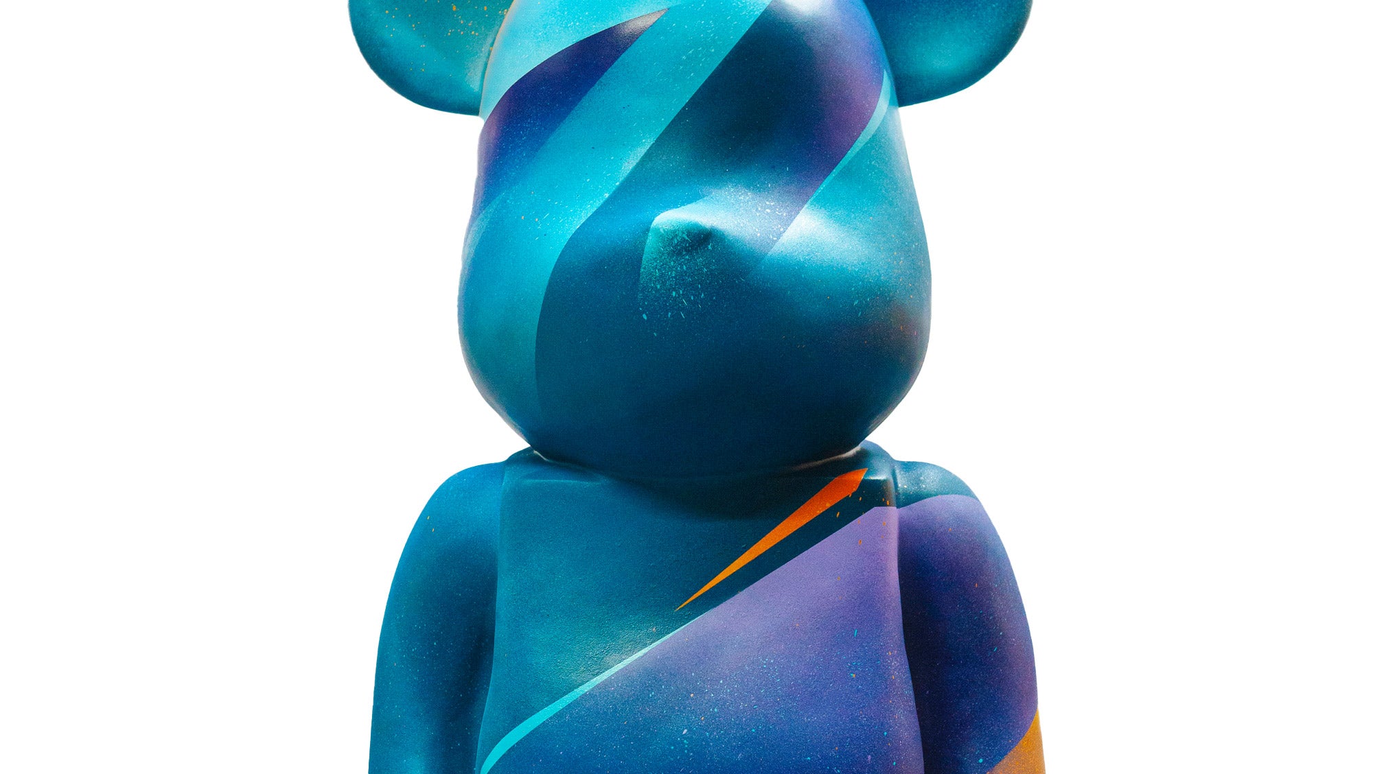 A large blue bear-shaped sculpture with abstract patterns and colorful gradients, including shades of teal, purple, and orange, on its surface. The artwork has a smooth, polished texture and stands against a white background.