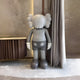 Slate Grey Iconify standing sculpture, side view, sophisticated grey figure, elegant and serene in a modern setting.