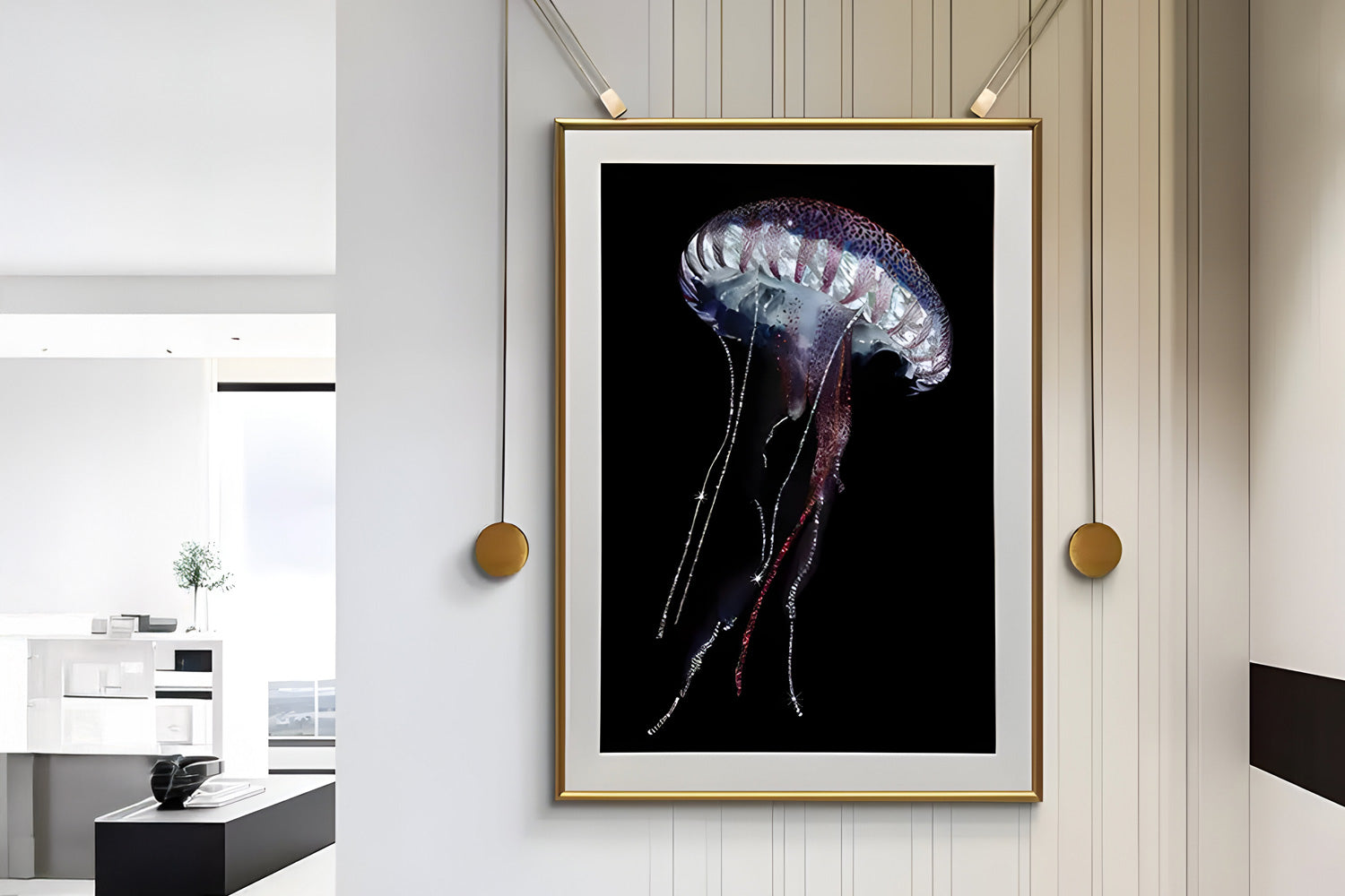 A framed picture of a jellyfish with long, flowing tentacles on a black background is displayed on a striped wall in a modern, minimalist room with a view of a sunlit window.