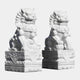 Two intricately hand-carved Chinese Guardian Lion II Marble Outdoor Sculptures by Giant Sculptures rest on decorative bases. These large marble statues boast detailed manes and fierce expressions, with one lion gripping a ball and the other playfully holding a cub beneath their mighty paws.