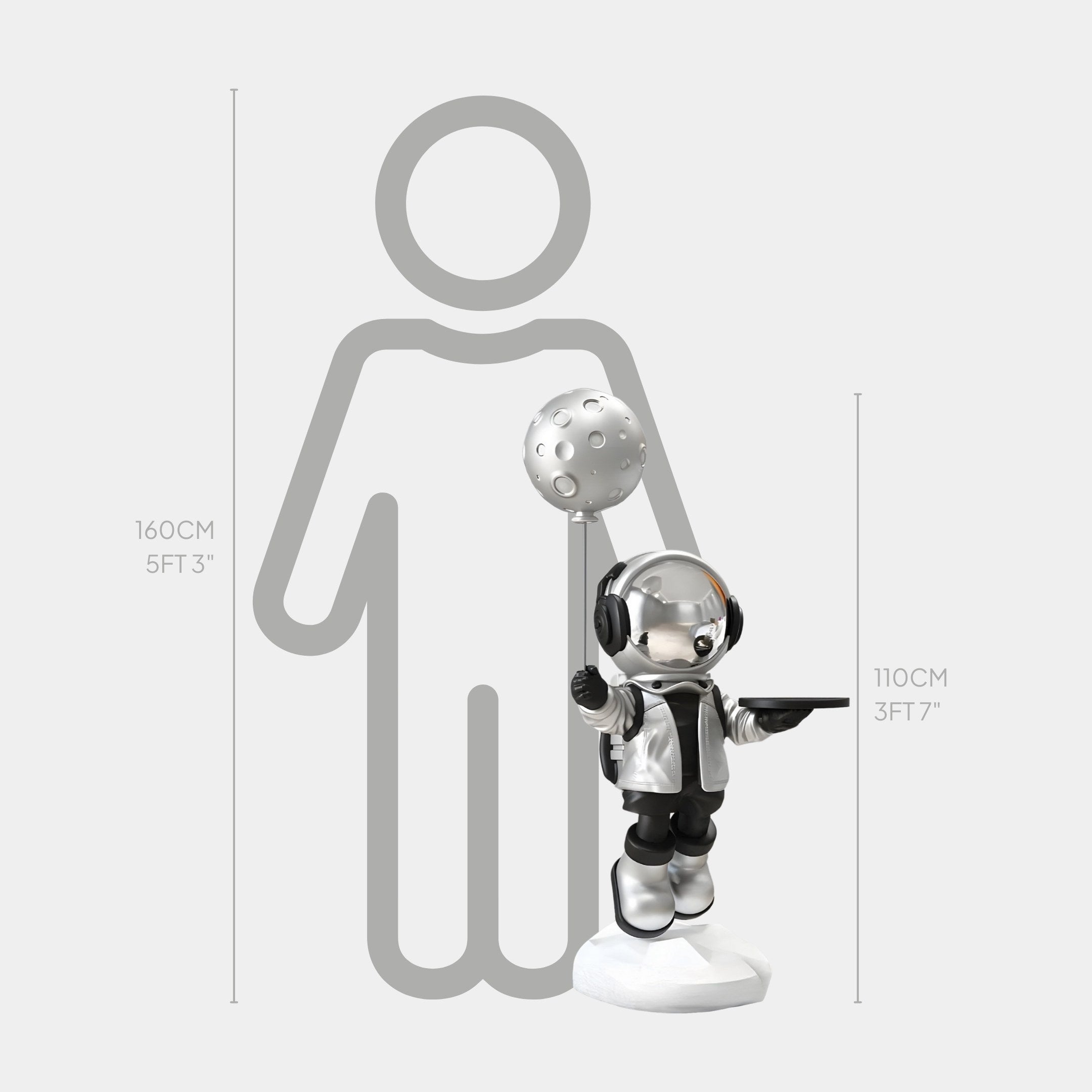 The Lunar Silver Astronaut Butler Balloon Sculpture by Giant Sculptures stands at 110 cm (3 ft 7 in) beside a human outline measuring 160 cm (5 ft 3 in), depicting a height comparison.