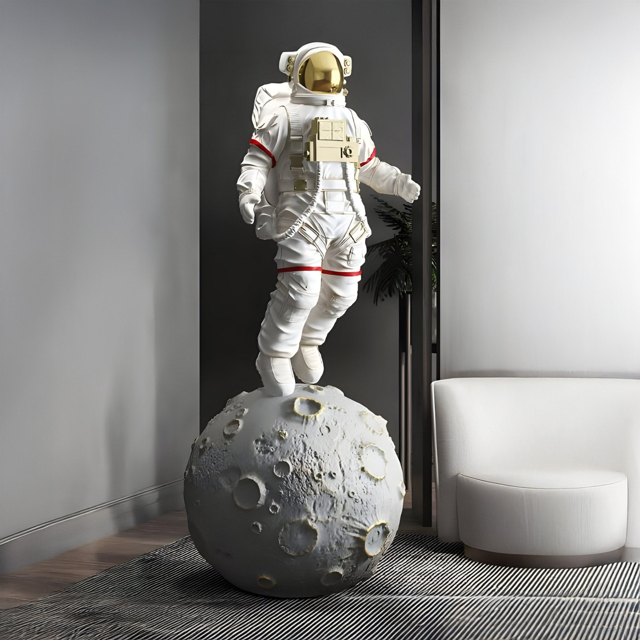 The Giant Sculptures White & Gold Space Astronaut Moonwalk Sculpture (128cm) elegantly enhances the rooms minimalist decor, featuring an astronaut in a white spacesuit atop a moon-like sphere, perfectly positioned on a wooden floor beside a modern white chair.