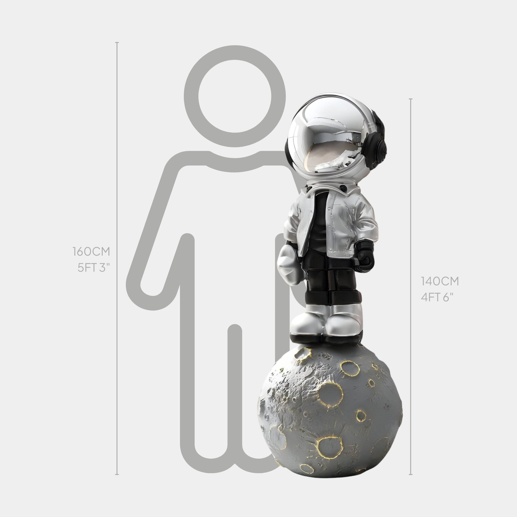 The Lunar Silver Astronaut Beats On Moon Sculpture by Giant Sculptures is 140 cm tall, showcasing an astronaut in a helmet and jacket on a textured lunar surface, complemented by a 160 cm silhouette for scale.