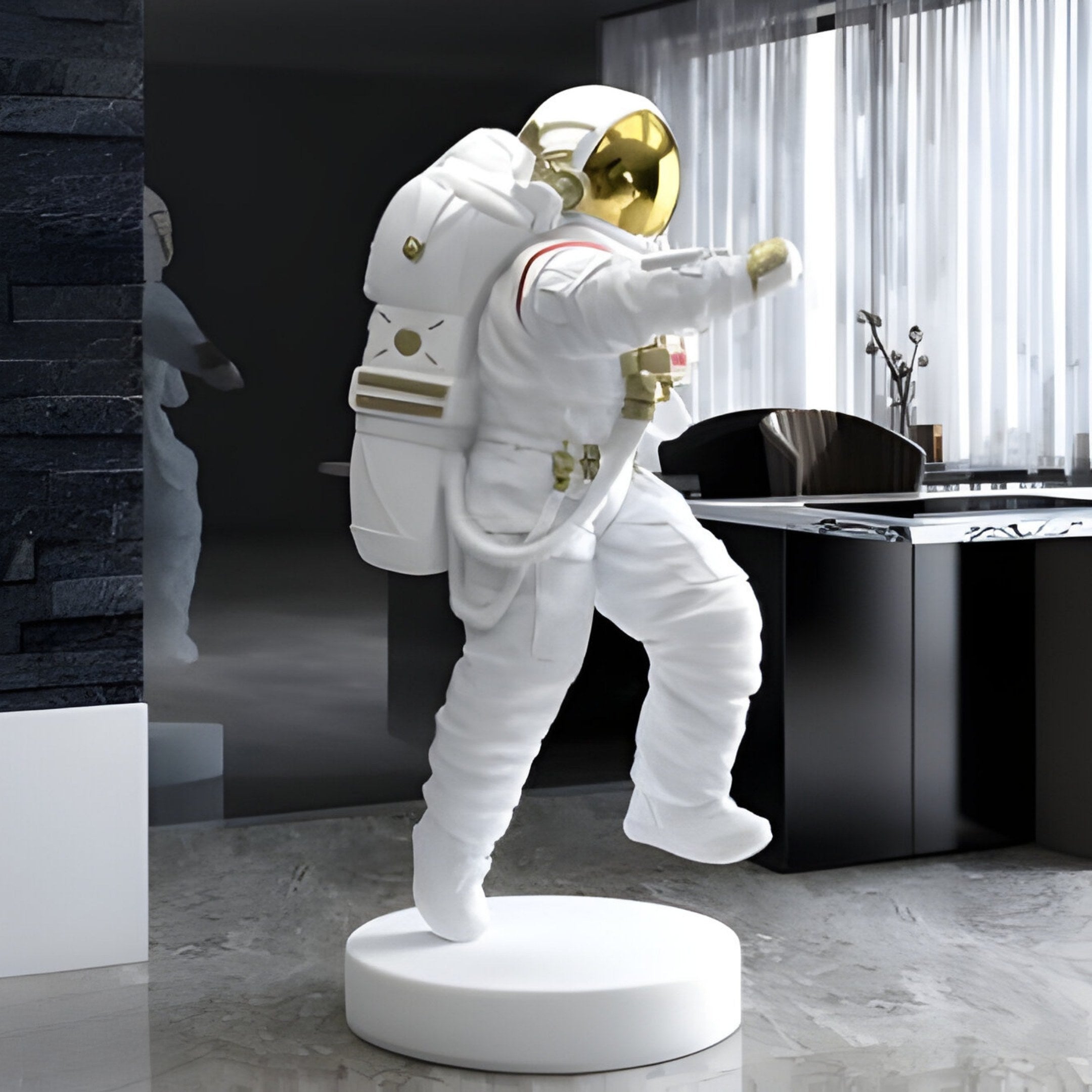 The 150cm White Space Astronaut Strider Sculpture by Giant Sculptures, complete with a reflective visor and backpack, is showcased indoors on a white circular stand. Set against a dark wall with modern design and large windows, its reflective elegance casts shimmering shadows nearby.