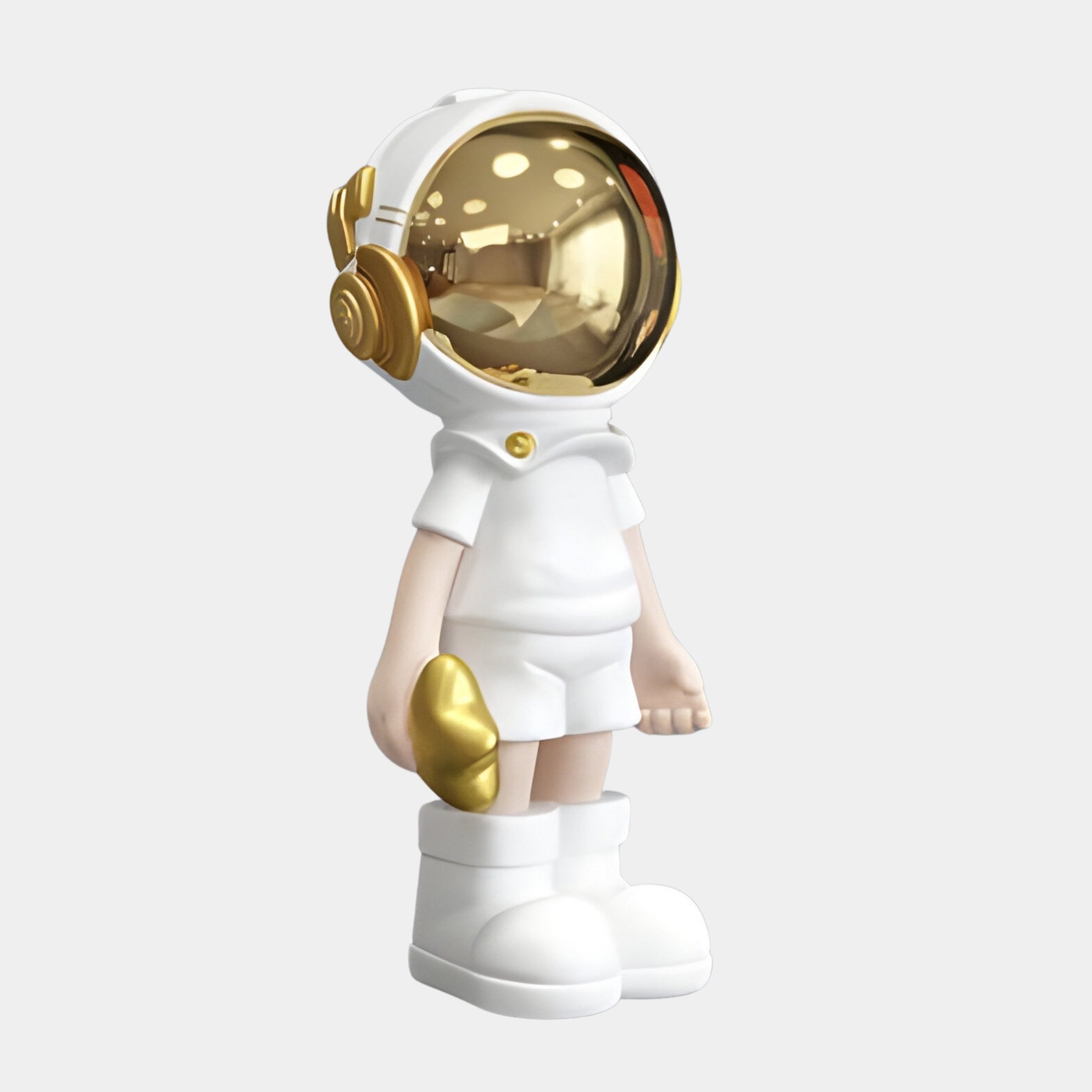 The Cosmic White Astronaut Buddy Figure from Giant Sculptures stands 36cm tall, featuring a sleek cosmic ornament suit with a shiny gold helmet, boots, and gloves. The polished helmet reflects a blurred indoor setting, offering an ideal space-inspired décor piece.