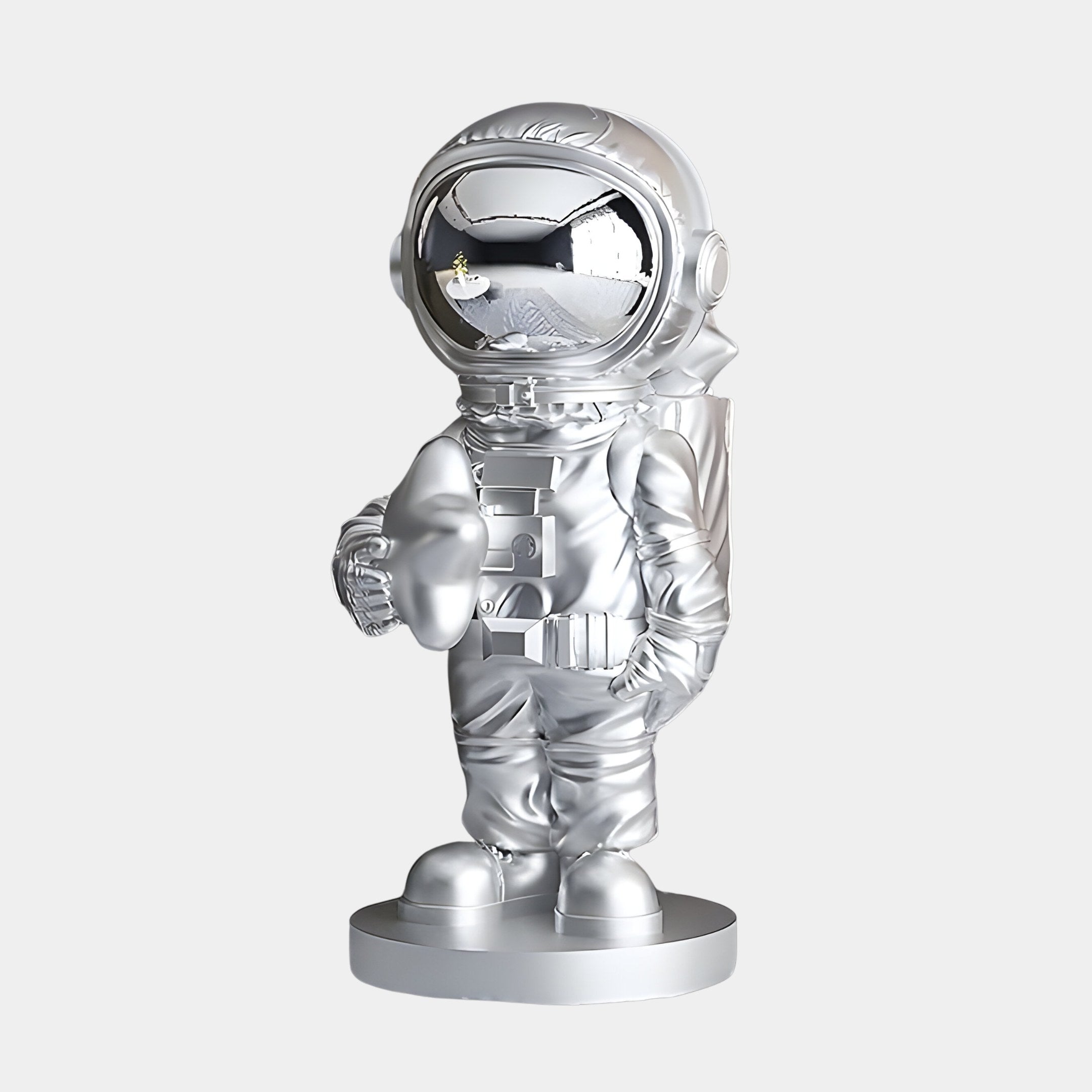 The Lunar Silver Astronaut Star Figure - 37cm by Giant Sculptures stands upright on a circular base, with a light-reflecting visor and a thumbs-up pose. Detailed with spacesuit features, this cosmic charm is set against a plain white background.