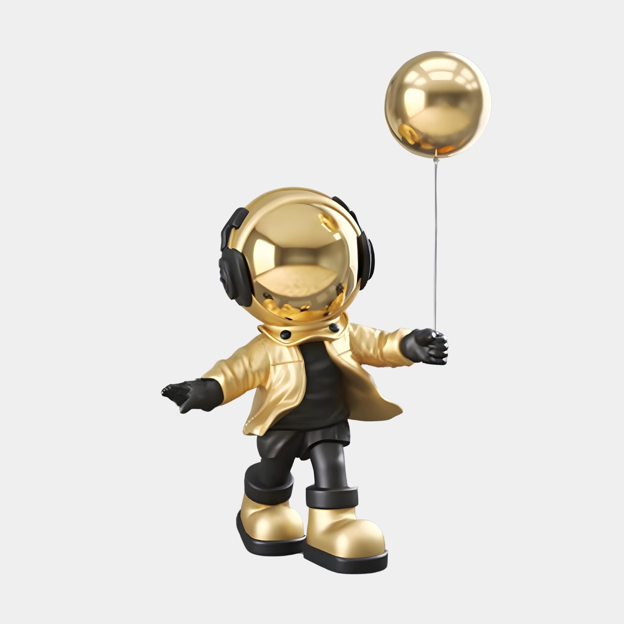 The Celestial Gold Astronaut Balloon Standing Figure by Giant Sculptures features a 48cm tall figure with a gold helmet, black headphones, and reflective sphere head. Dressed in a gold jacket, black pants, and boots, it holds an astronaut balloon against a light gray backdrop.