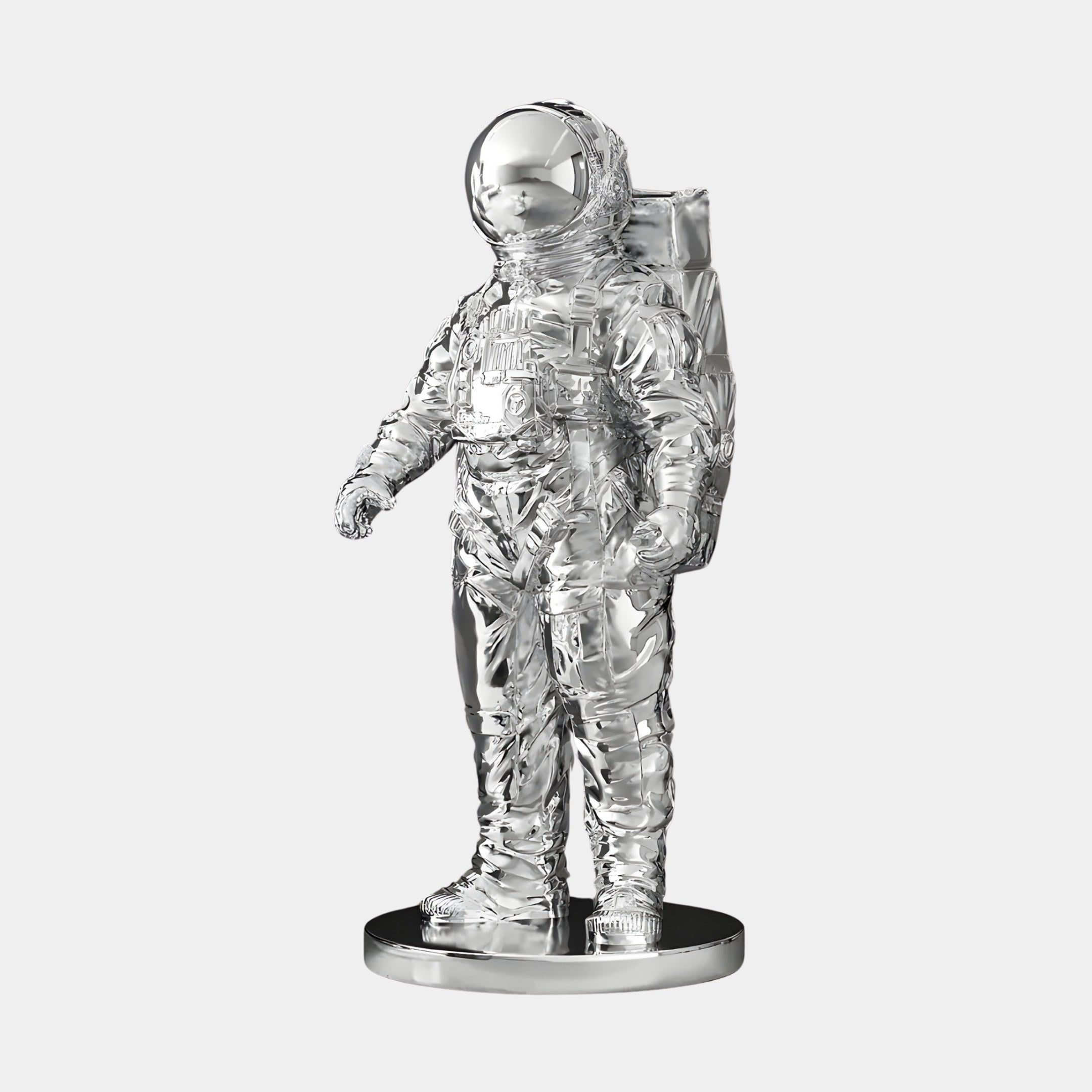 Giant Sculptures Cosmic Chrome Space Astronaut Standing Sculpture shines with a reflective finish. At 58cm, it features a detailed spacesuit with helmet and backpack atop a round base, perfect for catching light against any plain backdrop.