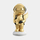 The Giant Sculptures Celestial Gold Astronaut Angel Rocket Sculpture, 75cm, showcases a gold astronaut with angel wings and a gleaming helmet. Standing on a white base, it holds a small rocket against a plain background.