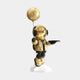 The Giant Sculptures Celestial Gold Astronaut Butler Balloon Sculpture showcases a dazzling helmeted figure in black gear, standing on a white base, holding an intricate balloon sculpture with cut-out circles atop a black tray, creating a striking space-inspired decor.