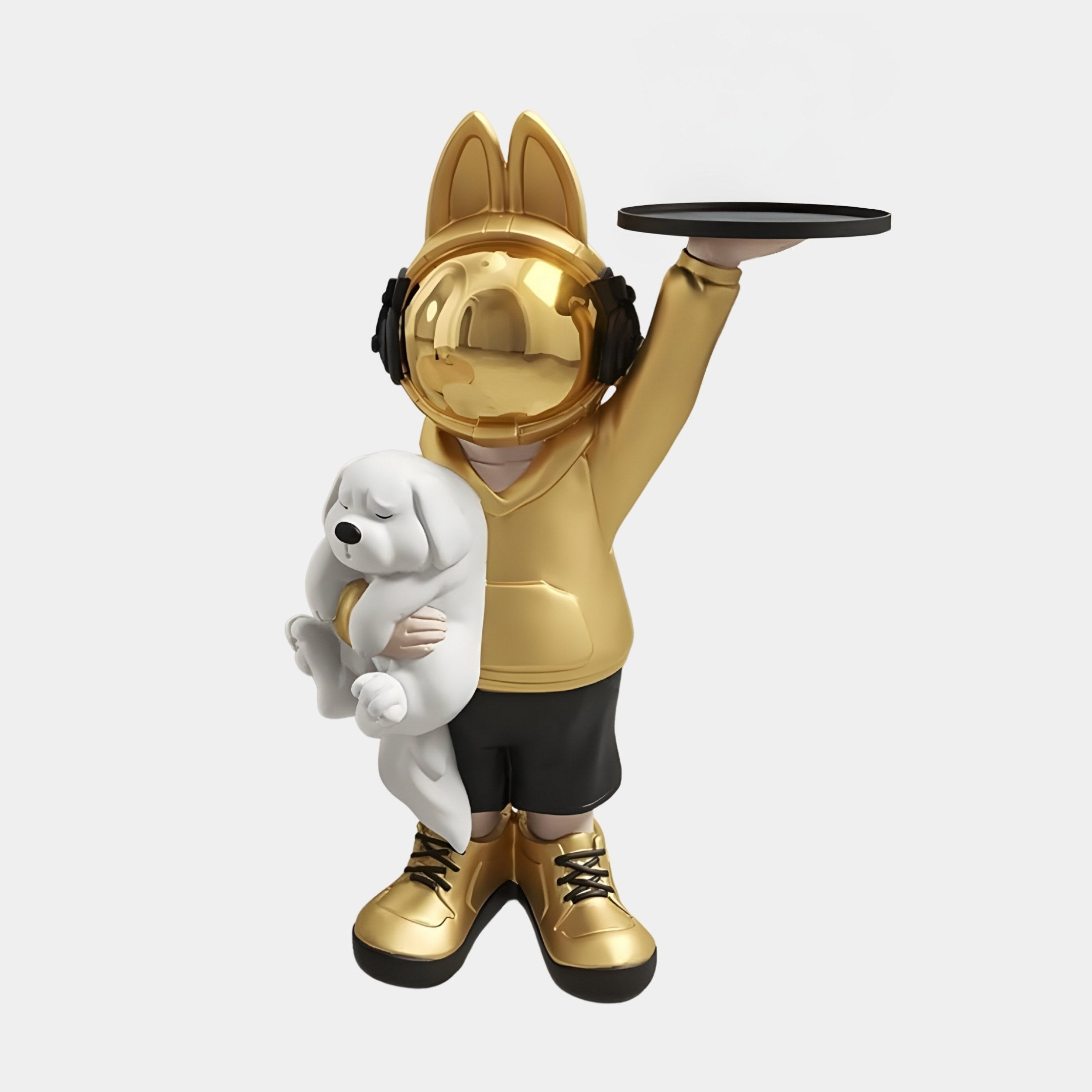 Introducing the Gold Astronaut Bunny Pup Butler Sculpture by Giant Sculptures, an 80cm whimsical statue featuring a child-like figure with a shiny gold helmet and rabbit ears. It holds a black tray while cradling a white puppy in a gold hoodie and black shorts.