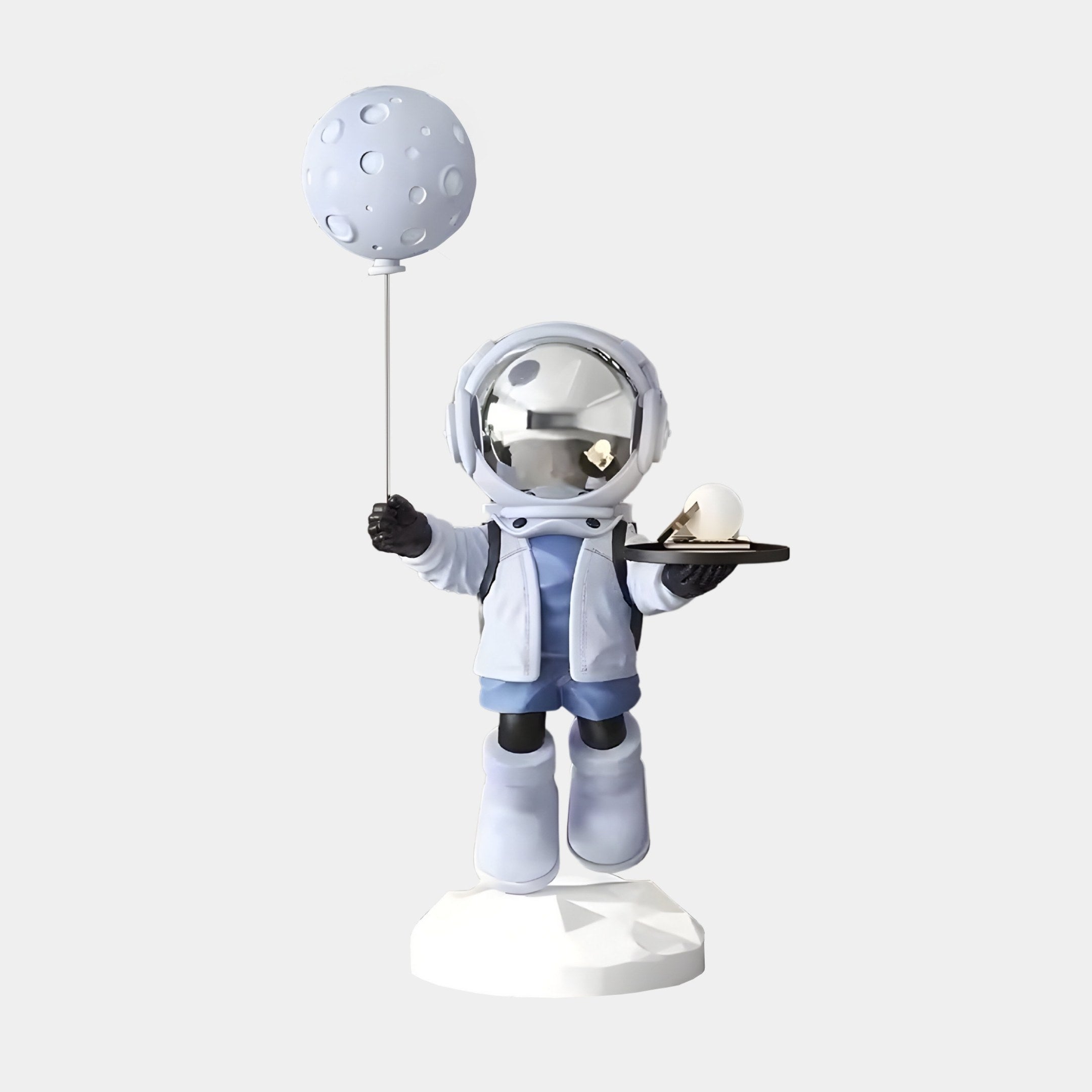 The 80cm Cosmic Sky Astronaut Butler Balloon Sculpture by Giant Sculptures features an astronaut in a light blue spacesuit and reflective helmet, holding a tray with a white sphere, moon-shaped balloon, and standing on a white base—perfect for enhancing your indoor decor.