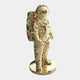 The Gilded Gold Space Astronaut Standing Sculpture by Giant Sculptures is a stunning 88cm piece, perfect for futuristic décor. It features a gold statue of an astronaut in a detailed spacesuit and helmet, standing on a round base and facing slightly right, set against a plain white background.