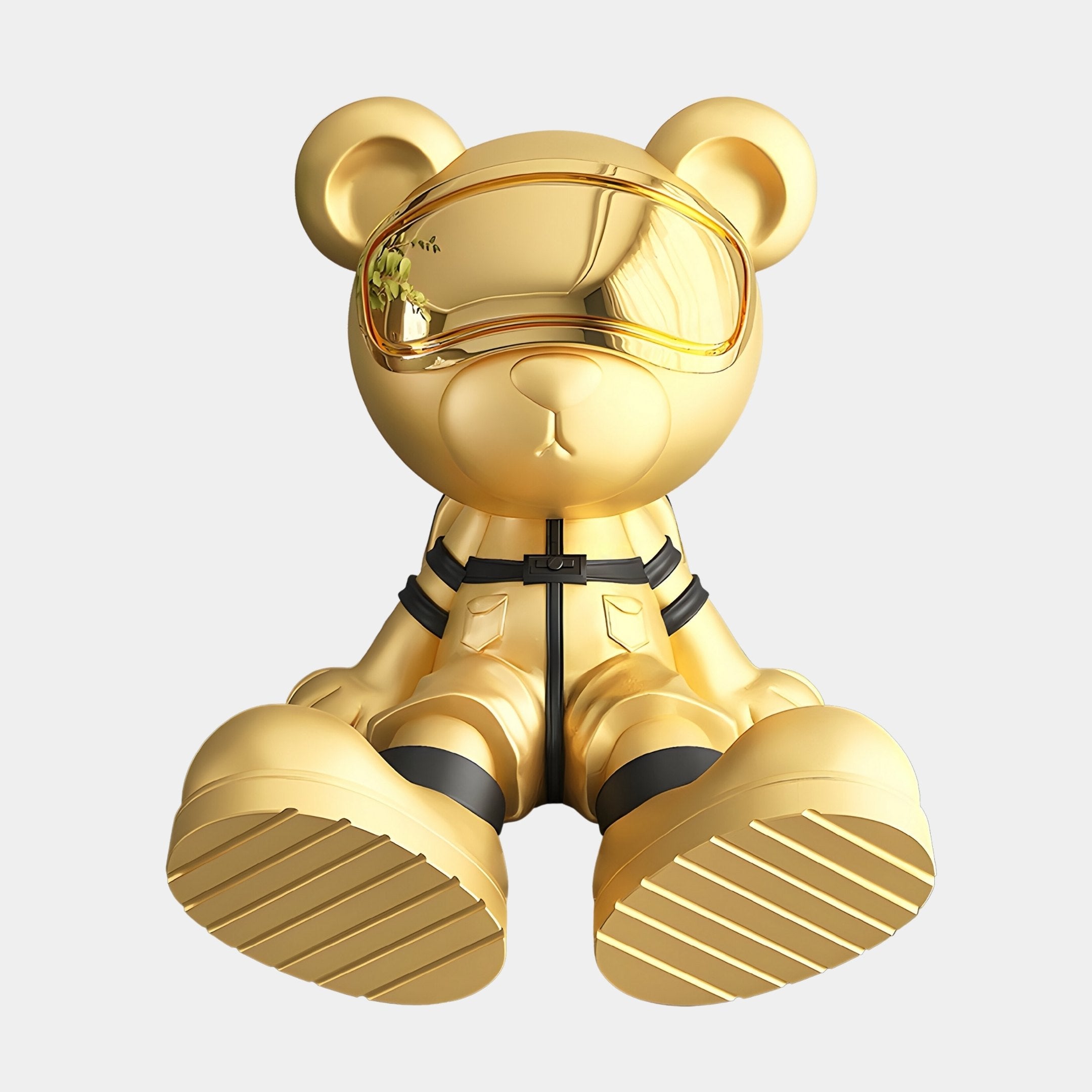 The Celestial Gold Astronaut Bear Sculpture by Giant Sculptures, standing at 51cm, features a futuristic visor, large shoes, and harness-like details that enhance its sleek modern vibe against a light gray background.