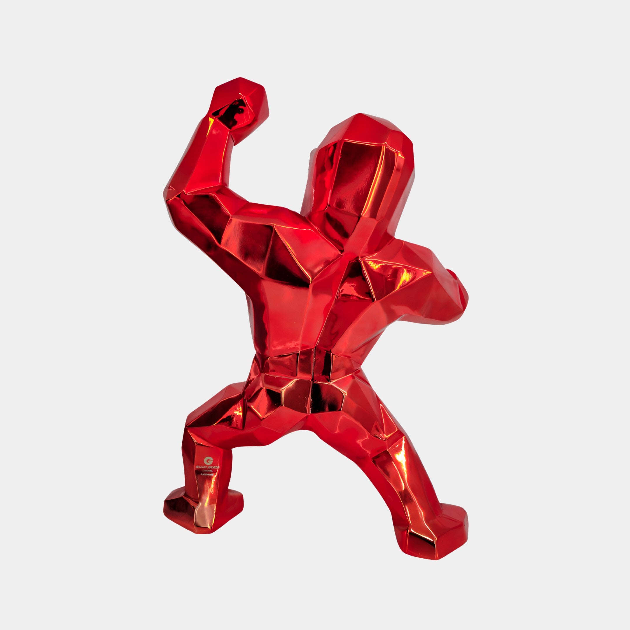 Back view of Fire Red Gorilla sculpture, highlighting its sleek, vivid red finish and dynamic pose for vibrant contemporary spaces.