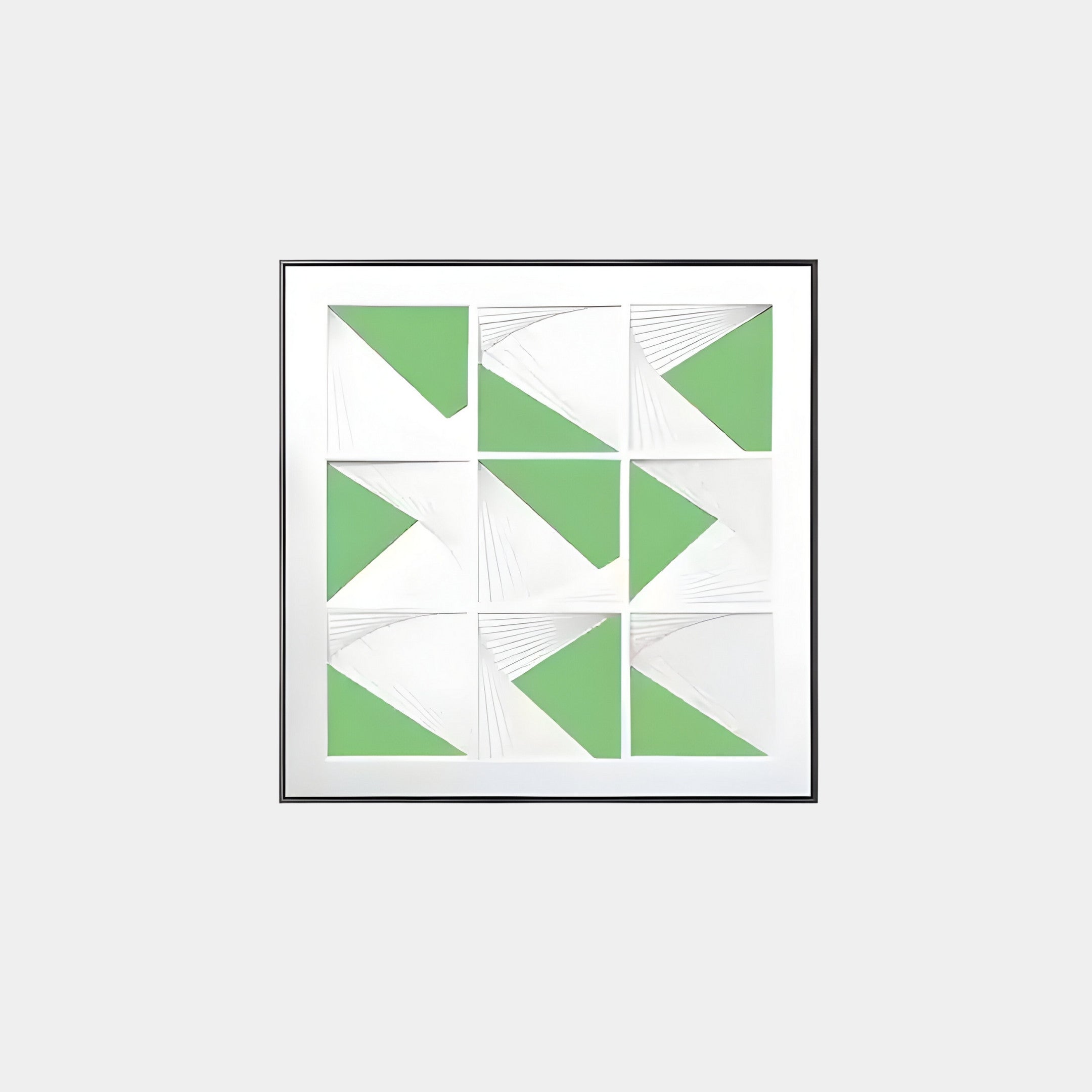 Prismatics Green Geometric Cardboard Carving Wall Art by Giant Sculptures features an abstract 3x3 grid of green and white shapes with diagonal lines, resembling triangles and quadrants, elegantly framed in aluminum against a light gray background.