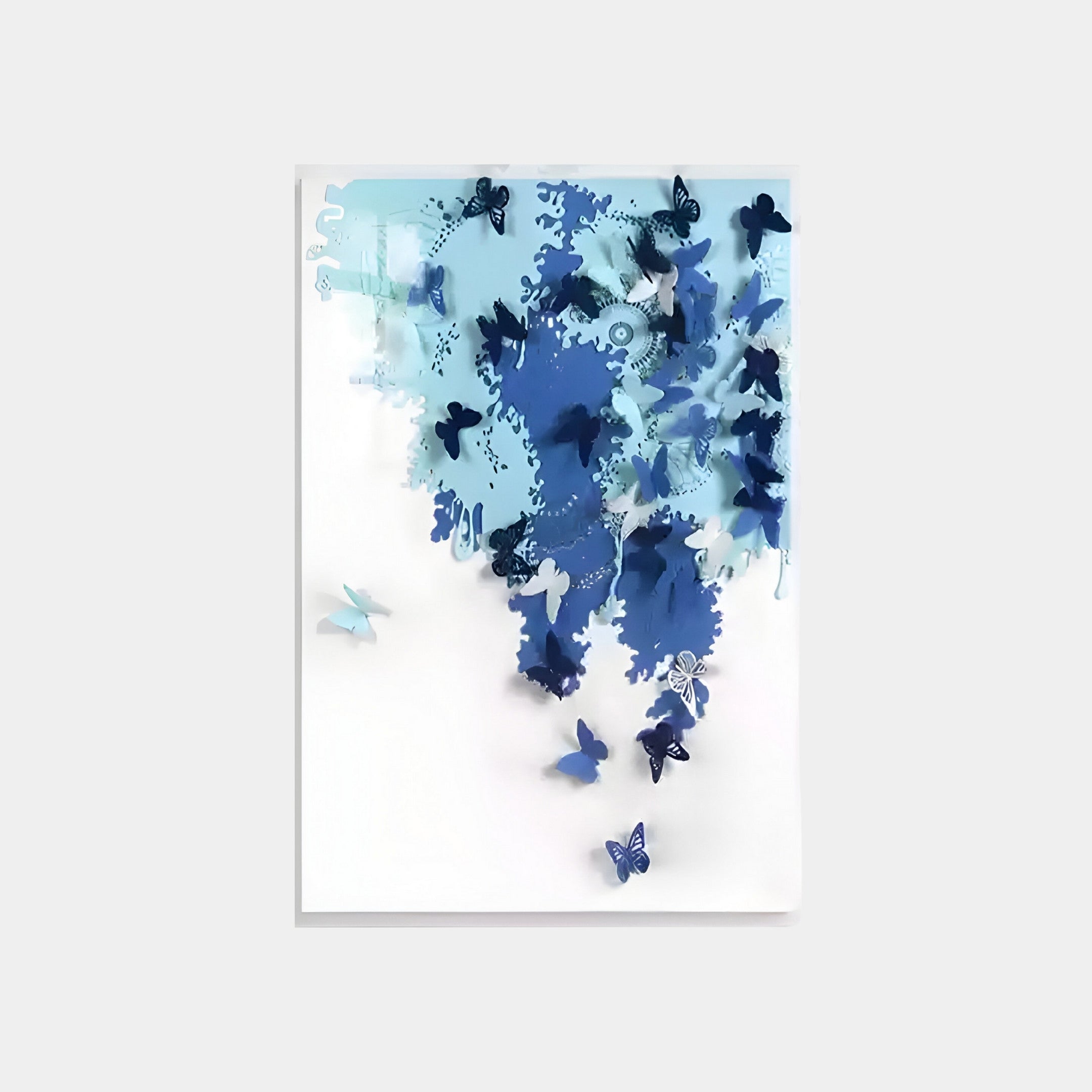 The Luminara Blue II Butterfly Paper 3D Wall Art by Giant Sculptures features handcrafted elegance with blue butterflies clustered in an abstract pattern. Some are dispersed, while others form a dense center group on a white background.