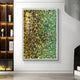 The Chromatica Vertical Vibrant Green 3D Wall Art by Giant Sculptures is mounted on a white wall. Framed in white, the large paintings textured, abstract design features vibrant green, yellow, and blue hues. Nearby, a modern shelving unit displays books and decor next to a sleek fireplace.