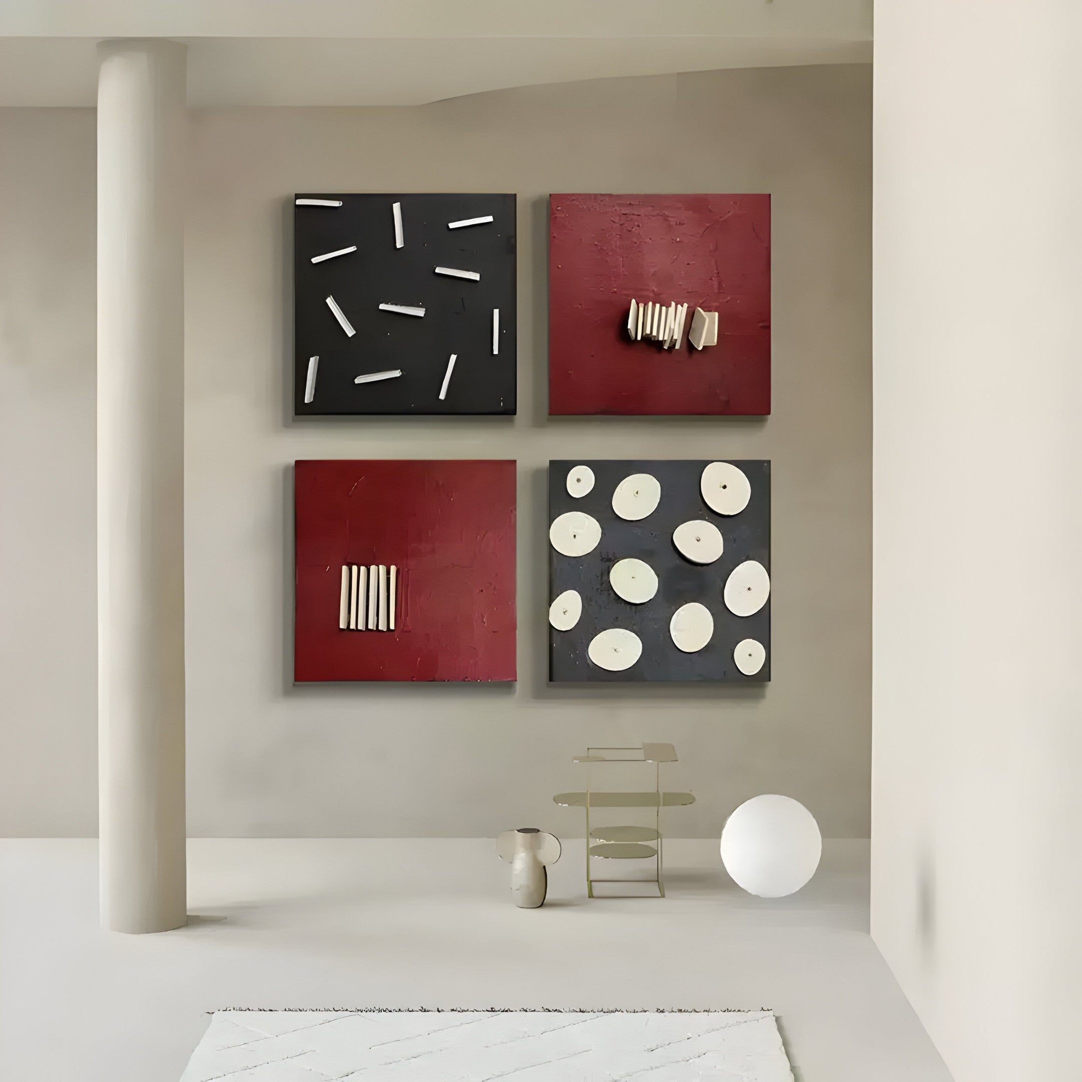 A modern, minimalist room featuring the Modulus Black & Red Quad Panel Set Abstract Wall Art by Giant Sculptures captures a wabi-sabi aesthetic. A small shelf with a vase and a white sphere on the floor complement the neutral tones and cylindrical pillar, enhancing its serene, Japanese-inspired design.