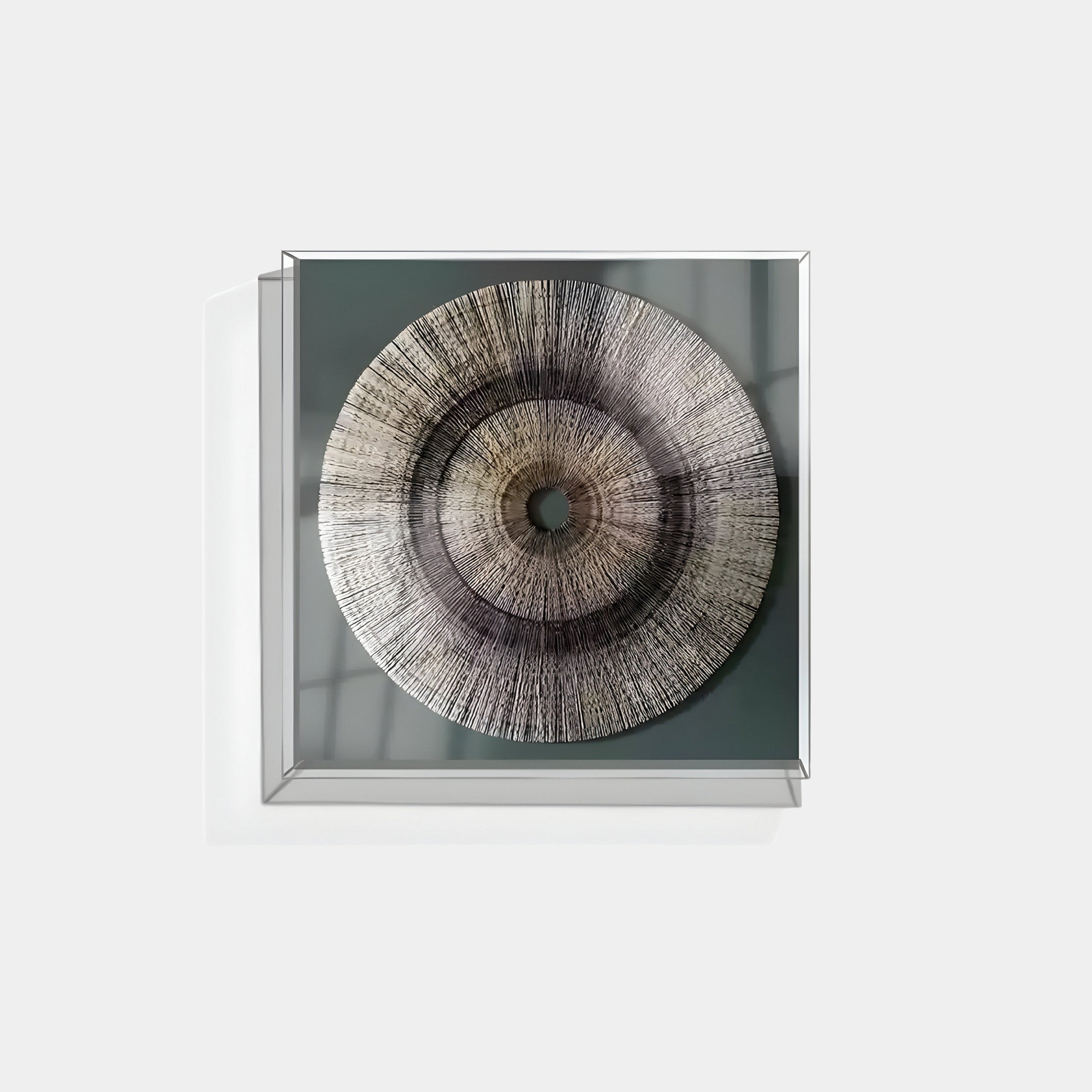 The handmade Oculis Neutral Depth Square 3D Paper Wall Art by Giant Sculptures is a wall-mounted, framed piece featuring a textured radial pattern in gray shades. This design evokes a stylized eye or abstract target, adding depth and movement against a light background.