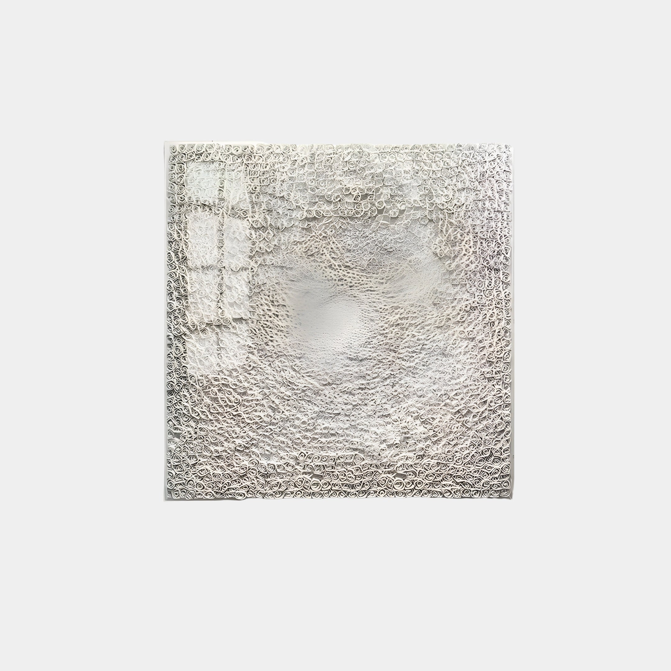 The TerraLuma Ivory White Bloom Paper Craft 3D Wall Art by Giant Sculptures features a textured white surface and intricate circular patterns that capture light and shadow, creating a dynamic, layered appearance reminiscent of delicate paper craft.