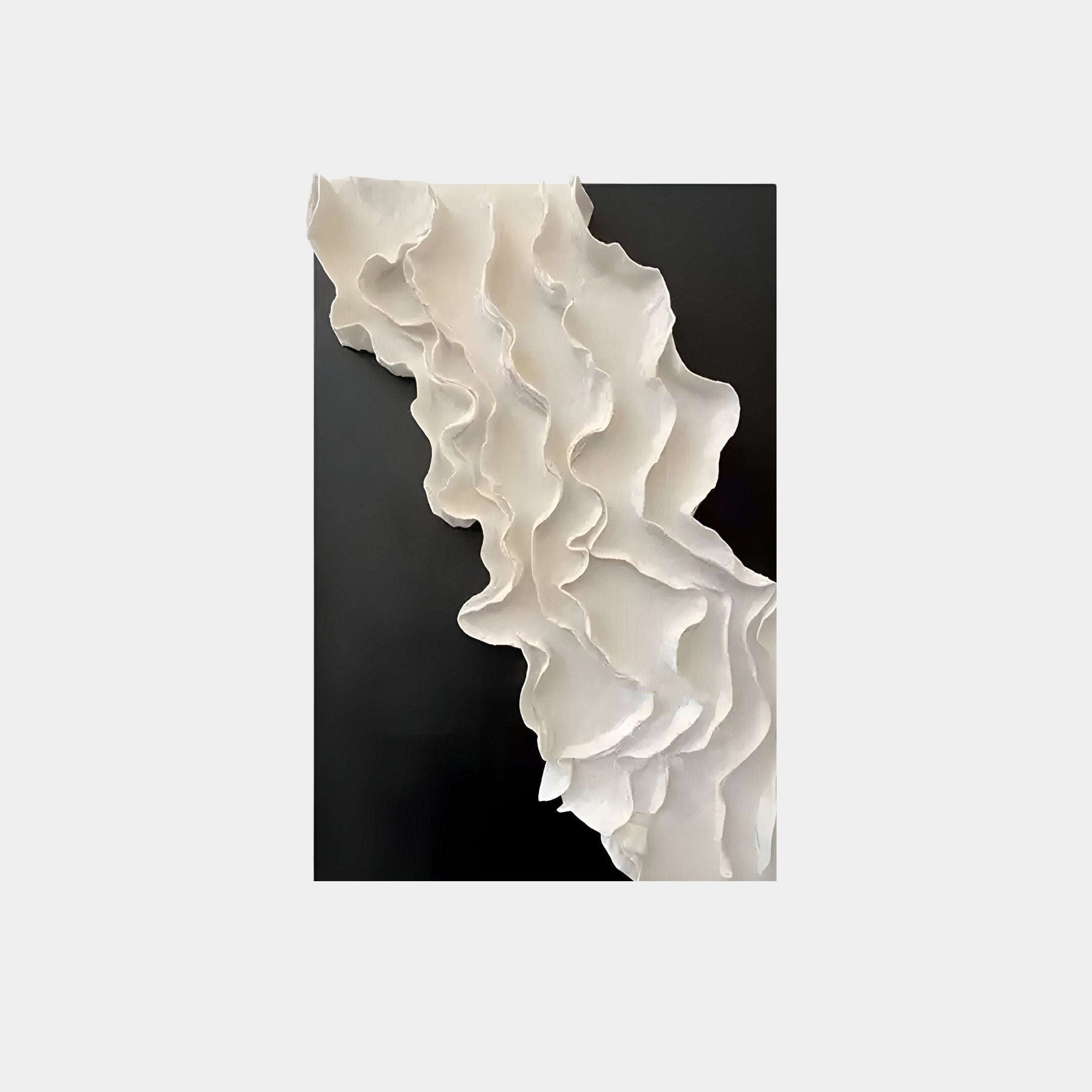 The Stratura IV Black & White Layered Paper Canvas Wall Art by Giant Sculptures features a wavy, textured white design resembling cascading fabric against a dark background, creating a striking monochrome contrast with organic, flowing forms that add movement and elegance to this modern piece.