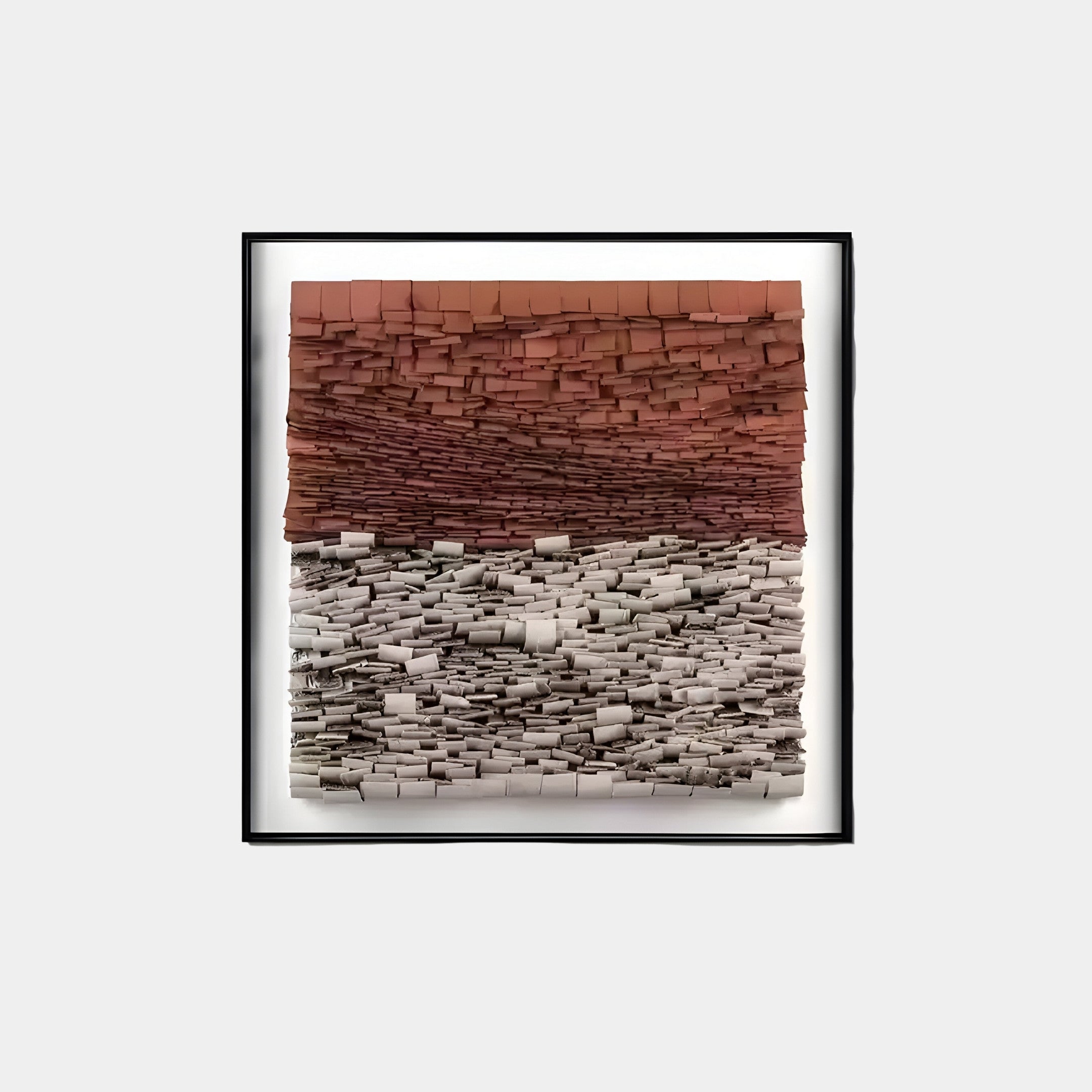 The Terracova Red Earthy Layers 3D Wall Art by Giant Sculptures features a framed piece with earthy, textured blocks in reddish hues on top and gray tones below, creating a visually striking, dimensional effect against its plain white background.