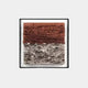 The Terracova Red Earthy Layers 3D Wall Art by Giant Sculptures features a framed piece with earthy, textured blocks in reddish hues on top and gray tones below, creating a visually striking, dimensional effect against its plain white background.