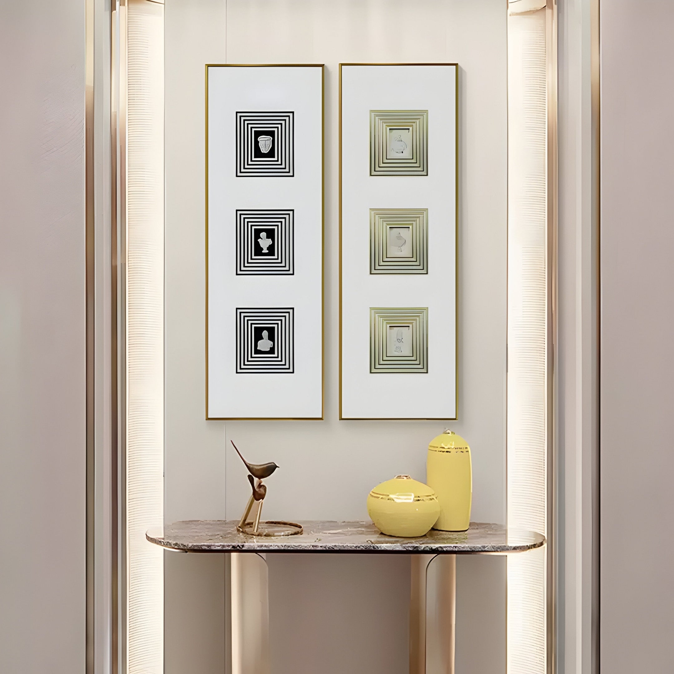 A modern interior showcases a marble console table with a metal bird sculpture, two yellow vases, and Giant Sculptures Lustre Golden Illusion plaster statue. Two framed geometric black and gold Vertical Wall Art pieces hang above, their golden shimmer illuminated on the softly lit wall.