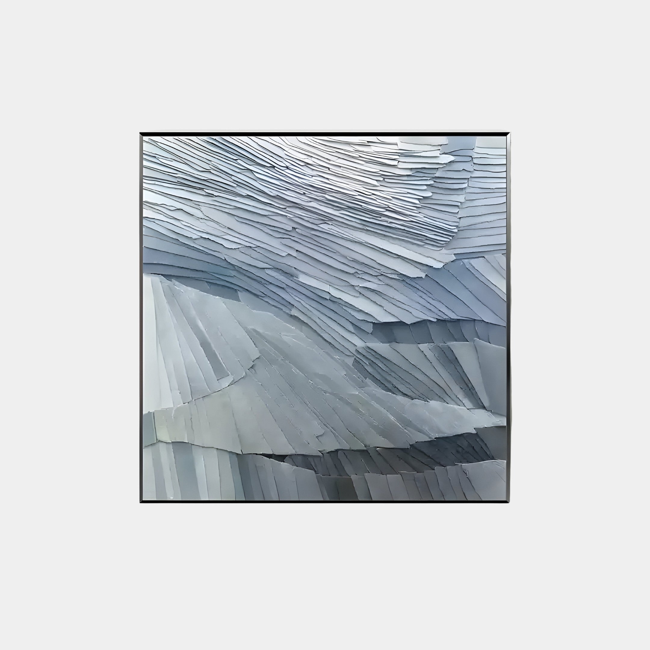 The Terrane Tranquil Blue Layered Abstract Wall Art by Giant Sculptures features gray and blue geometric shapes resembling folded paper. The overlapping pieces create a wave-like pattern, conveying movement and texture with a wabi-sabi style appreciation for imperfection.