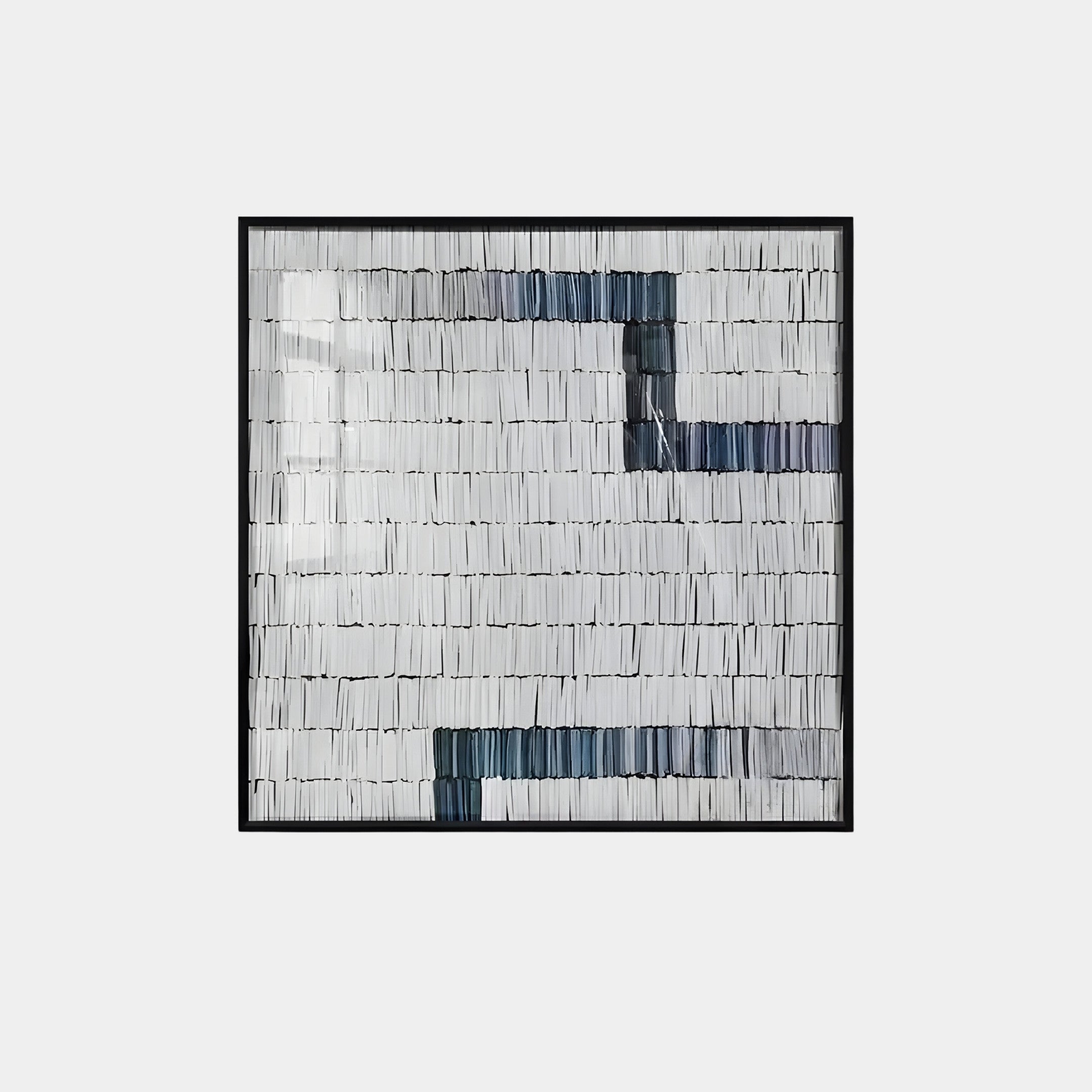 Tracery IV Blue & White Textured Paper Wall Art by Giant Sculptures showcases a square abstract design of vertical lines in black, white, and gray. The minimalist pattern includes geometric forms and is framed in black.