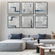 A modern living room showcases a gray modular sofa with blue-gray cushions. Six abstract framed artworks by Giant Sculptures, titled Tracery IV Blue & White Textured Paper Wall Art, adorn the wall. A small round coffee table displays decor, and brown dried plants enhance the minimalist palette.