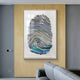 The Imprint Multi-Coloured Fingerprint Personalised Abstract Wall Art by Giant Sculptures, featuring blue, gray, and black tones on wooden paneling, serves as a centerpiece in a modern room with gray walls and a sleek gray sofa.