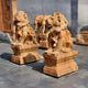 Giant Sculptures customizable Giant Lion Yellow Marble Outdoor Sculptures, standing at 150cm, feature intricately carved manes and lifelike details. They sit majestically on square pedestals outdoors, basking in sunlight and casting gentle shadows on a smooth stone surface.