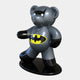 The Giant Sculptures limited-edition Gacko Batman Bear Sculpture stands 165cm tall on a sleek black base. It features a glossy grey body, black ears and limbs, with a yellow Batman logo on its chest, striking a dynamic pose against a plain white background.