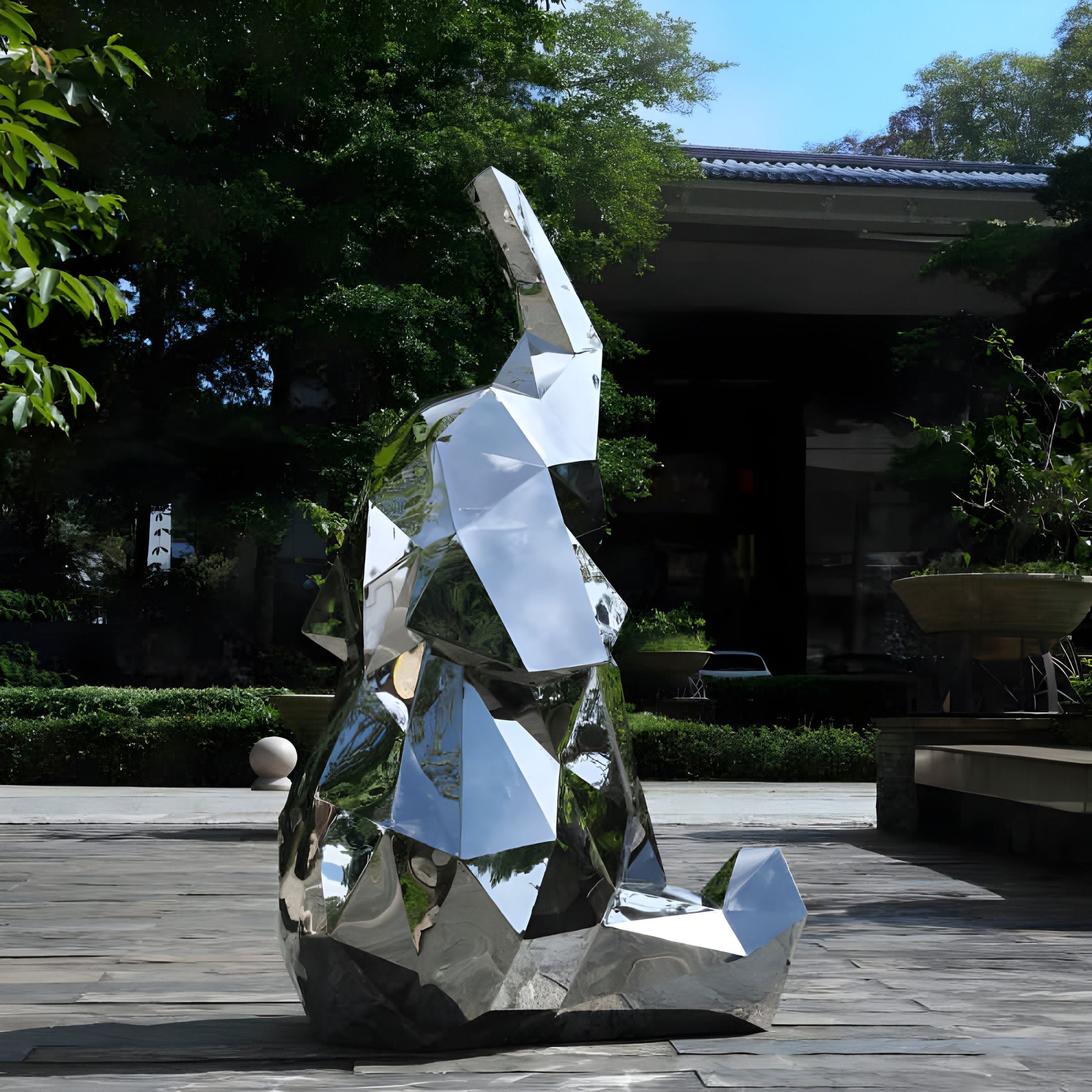 The elephant sculpture displayed in an outdoor garden area.