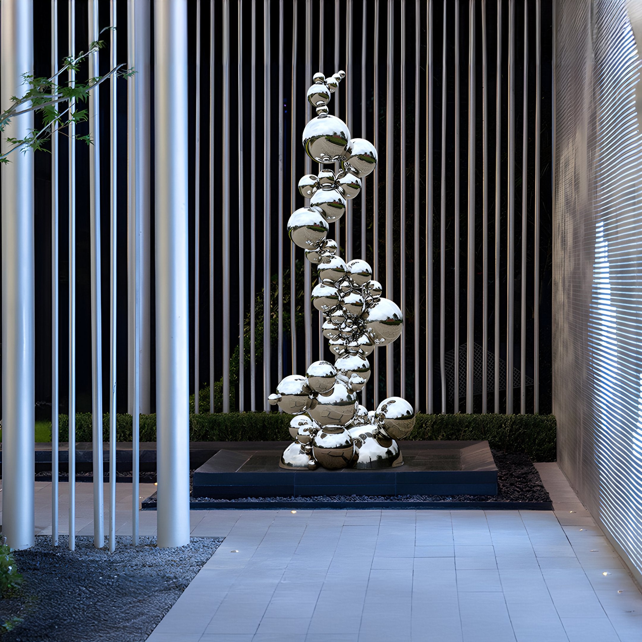 Stainless steel sculpture installed in modern corporate courtyard, reflecting the surroundings with its polished surface.