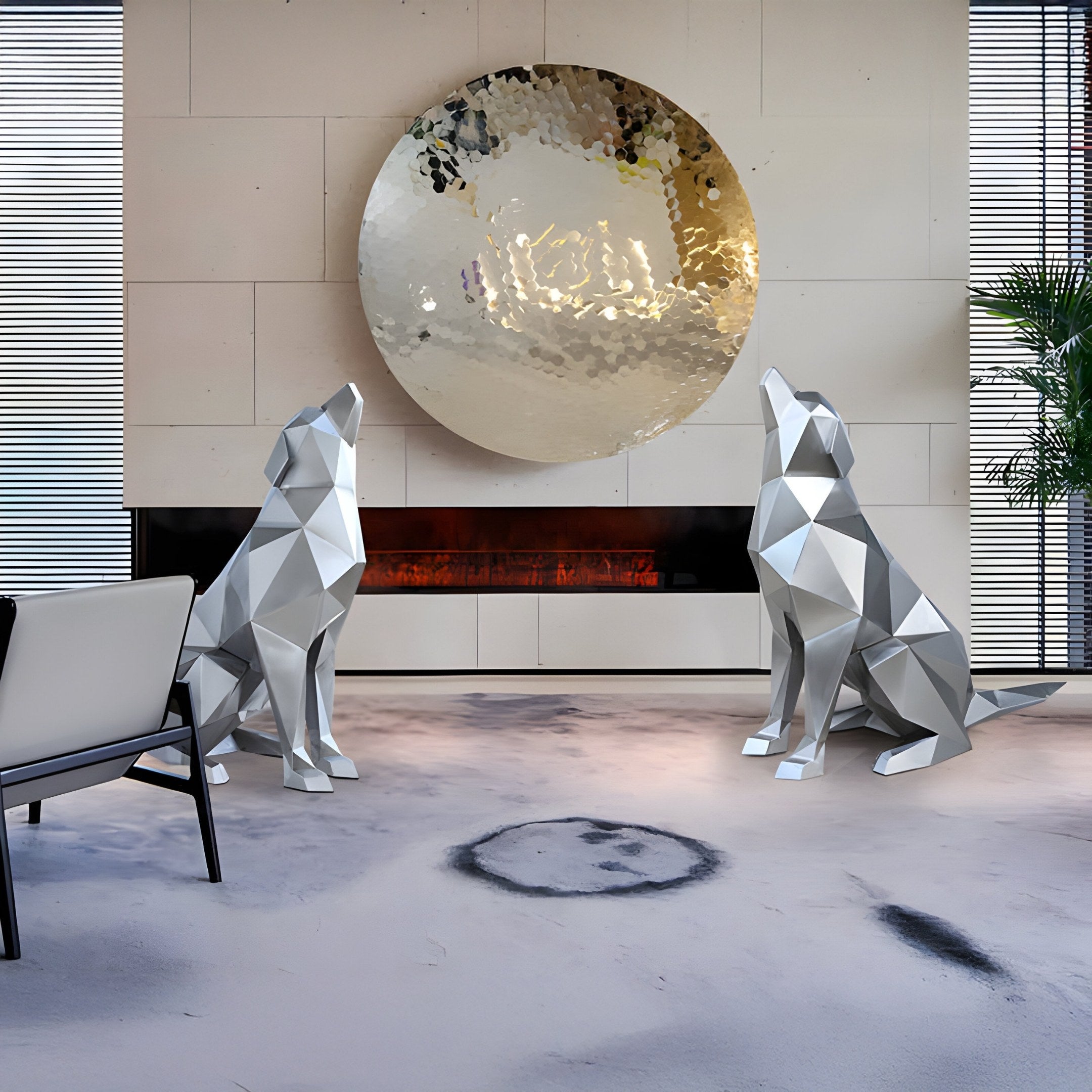 In a modern room, two Giant Sculptures Howling Dog Silver Geometric Steel Sculptures (100cm) face each other beneath a large metallic wall piece above a sleek fireplace. A contemporary chair is on the left, with a plant on the right. Dark abstract flooring enhances this modern canine art display.