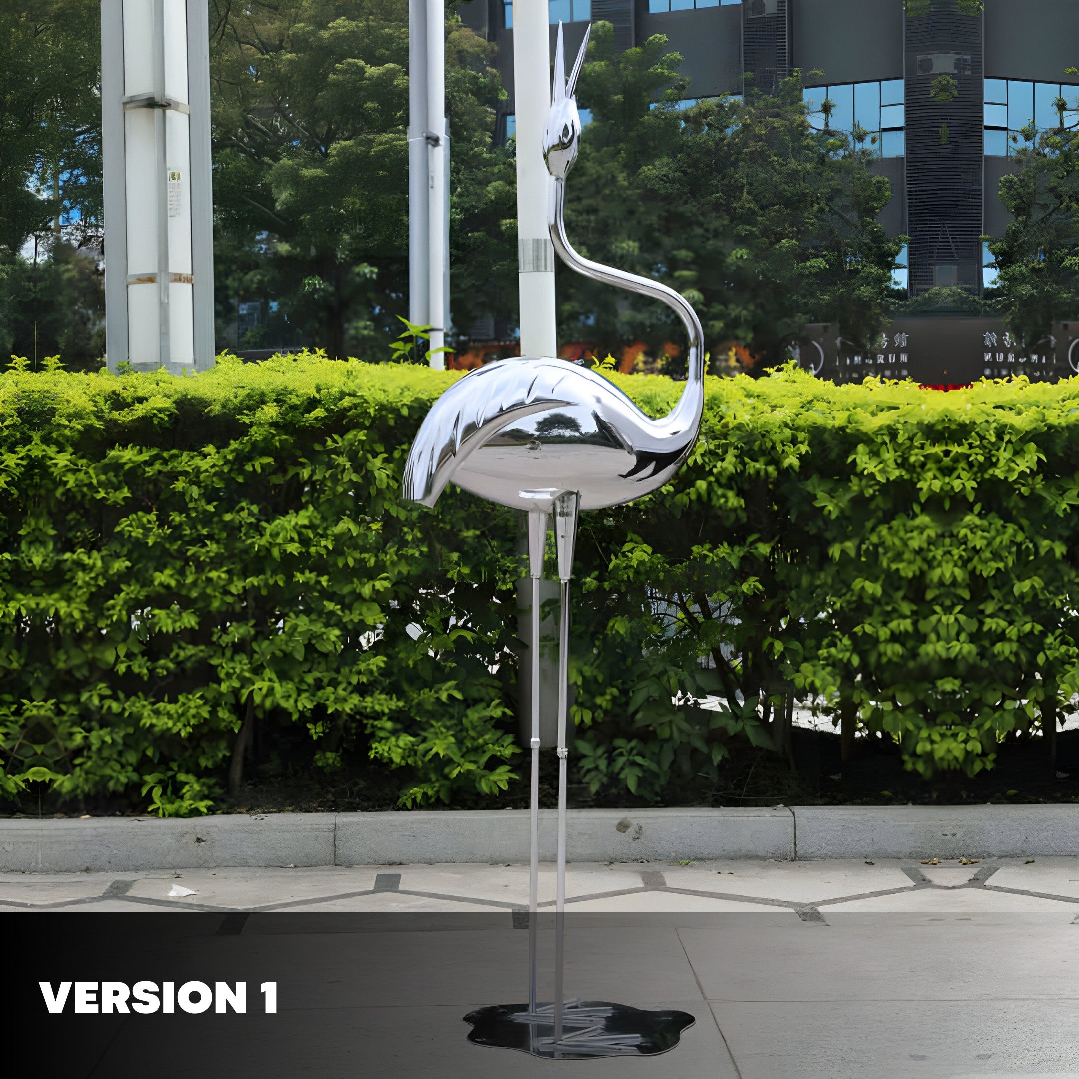 A single silver flamingo sculpture outdoors with a backdrop of green hedges, casting a shadow on the ground.