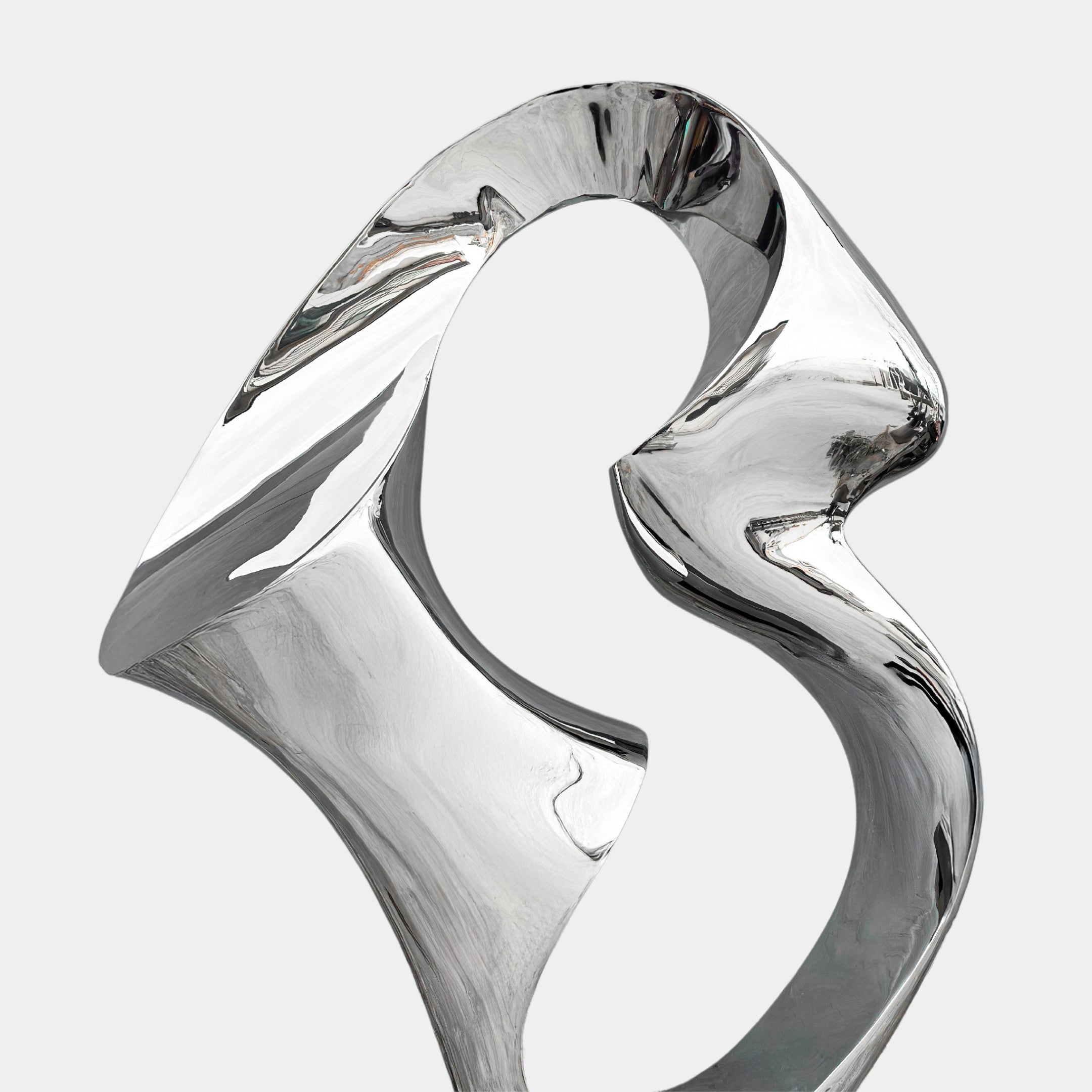 Discover the Flow III Silver Organic Steel Sculpture by Giant Sculptures. At 96cm, its fluid lines and curved surfaces create elegant reflections. This weather-resistant piece features intertwined loops like ribbons against a gray backdrop, making it a modern masterpiece.