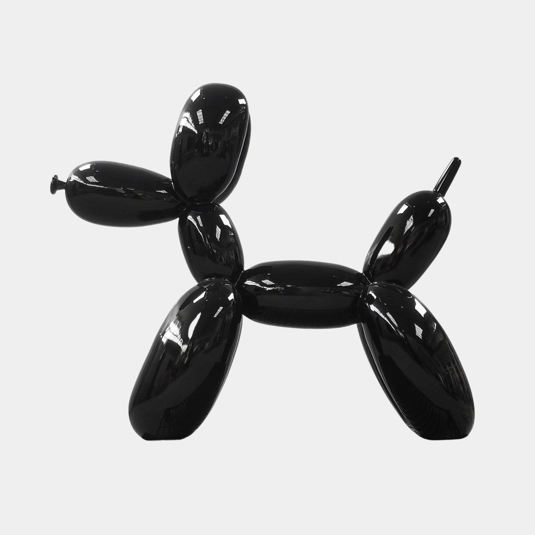 The 80cm Onyx Black Balloon Dog Sculpture by Giant Sculptures, with its shiny, light-reflecting surface, serves as a striking piece of contemporary art against a plain white background.