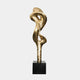 Gold-colored abstract sculpture with flowing, intertwined curves on a black base.