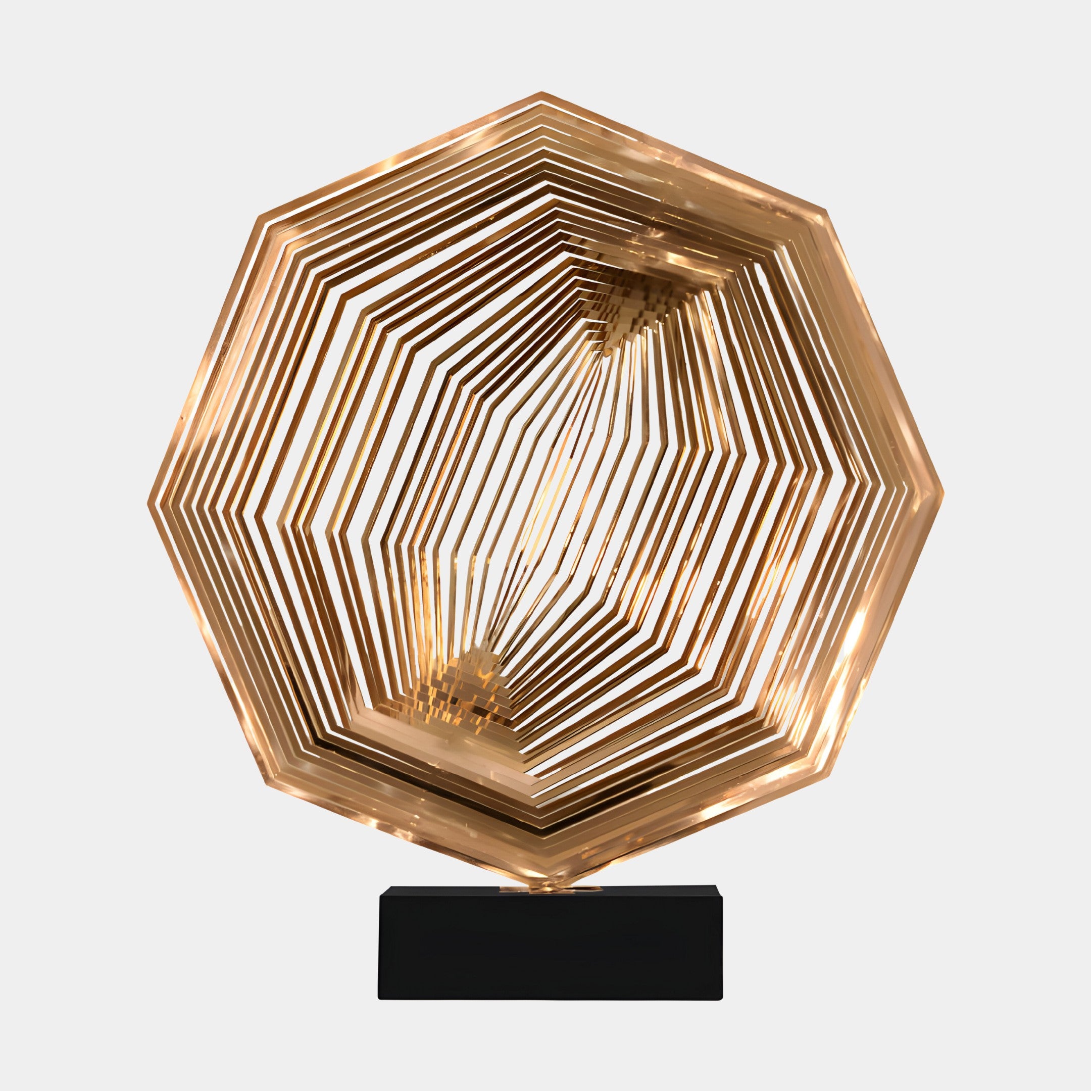 Golden hexagonal layered sculpture placed on a modern black pedestal in an elegant home setting, near a television.