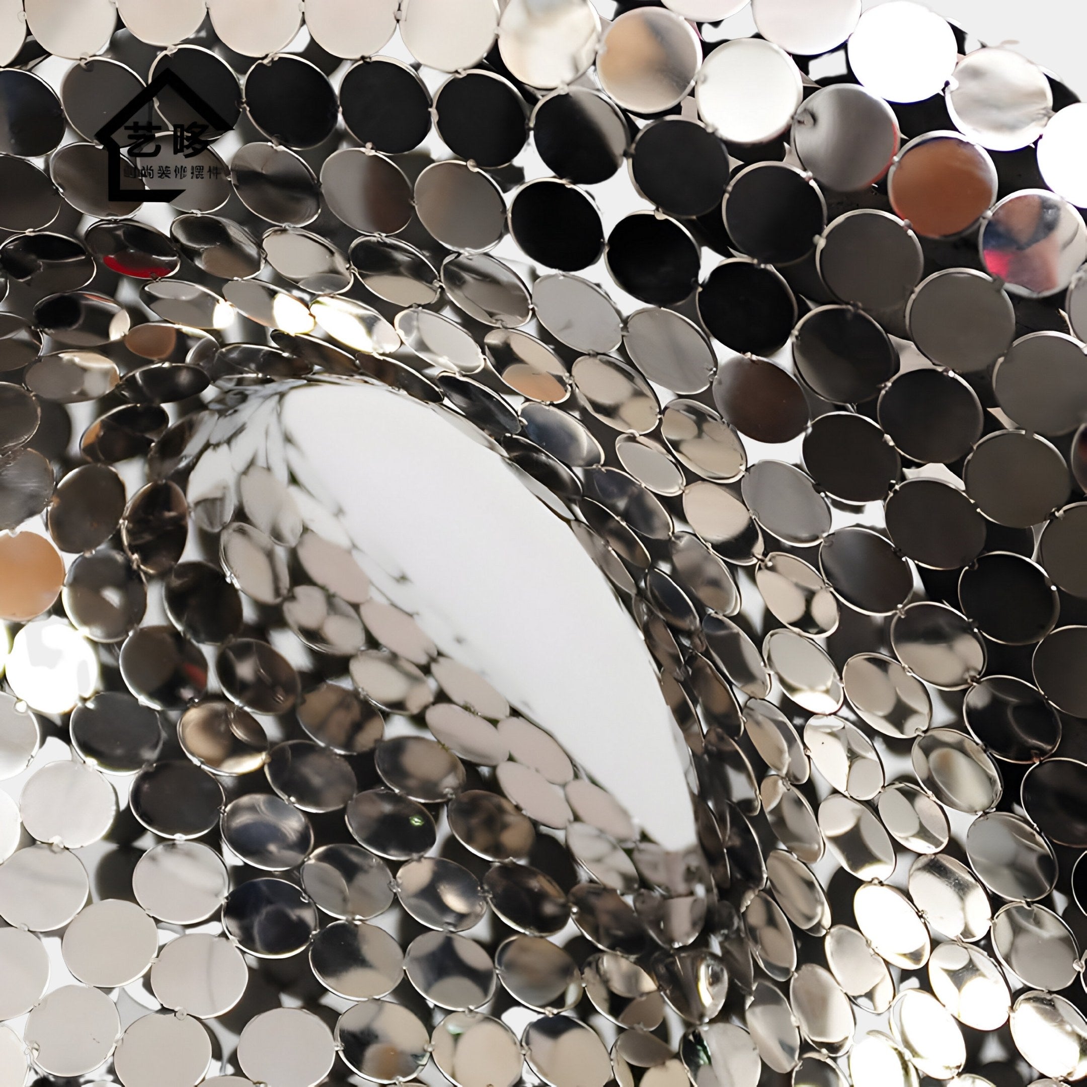 The Liquid Aura Silver Steel Sculpture - 238cm by Giant Sculptures features shiny, metallic discs in a swirl pattern, creating an abstract texture. It reflects light and surroundings with varying shades of silver and gray for a captivating visual effect.