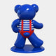 The Gacko Sailor Bear Sculpture by Giant Sculptures is a glossy blue, 165cm tall figure in a red and white striped outfit with red suspenders. It embodies nautical pop art, standing on a round base in a walking pose facing left.