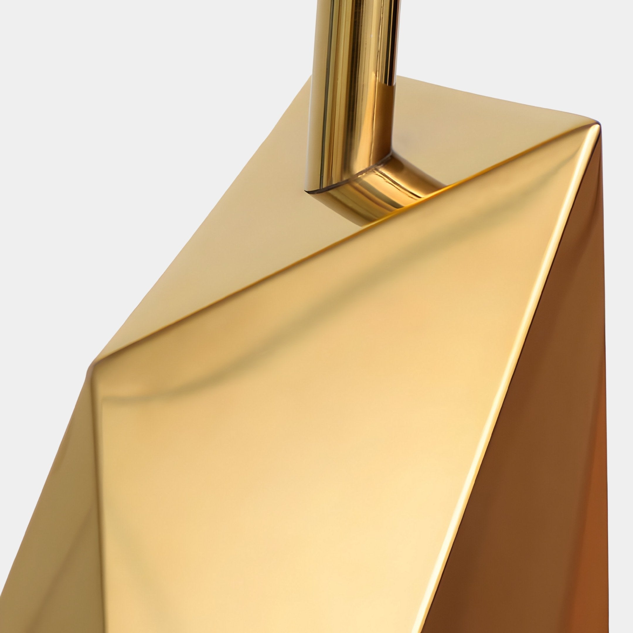 Close-up of the Prism Gold Geometric Steel Sculpture by Giant Sculptures, featuring sleek, angular lines and smooth, reflective surfaces. This modern 80cm piece showcases sharp edges and a minimalistic look, ideal for complementing any neutral space decor.