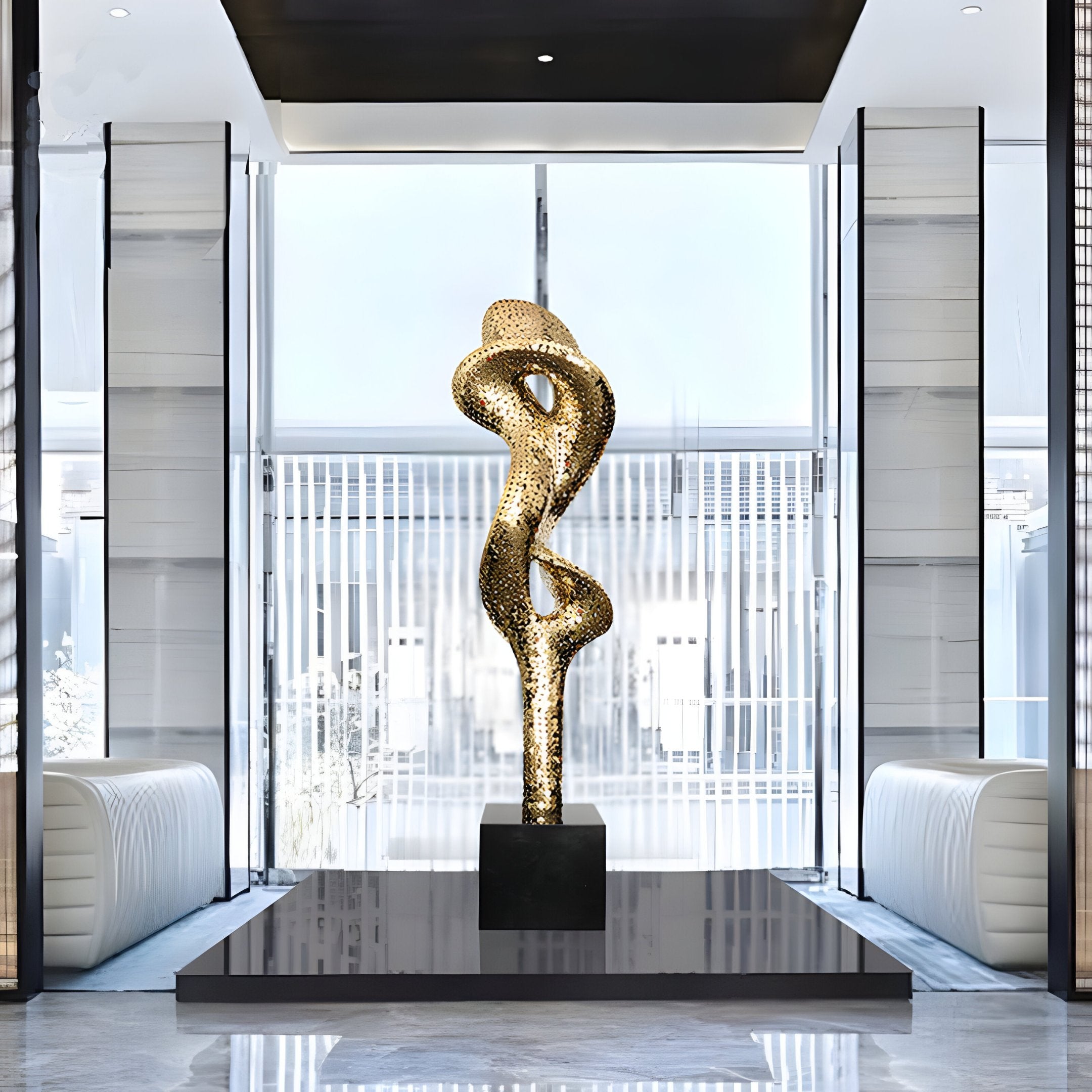 Gold-colored abstract sculpture placed in a luxurious, open interior with large windows, highlighting its golden sheen.